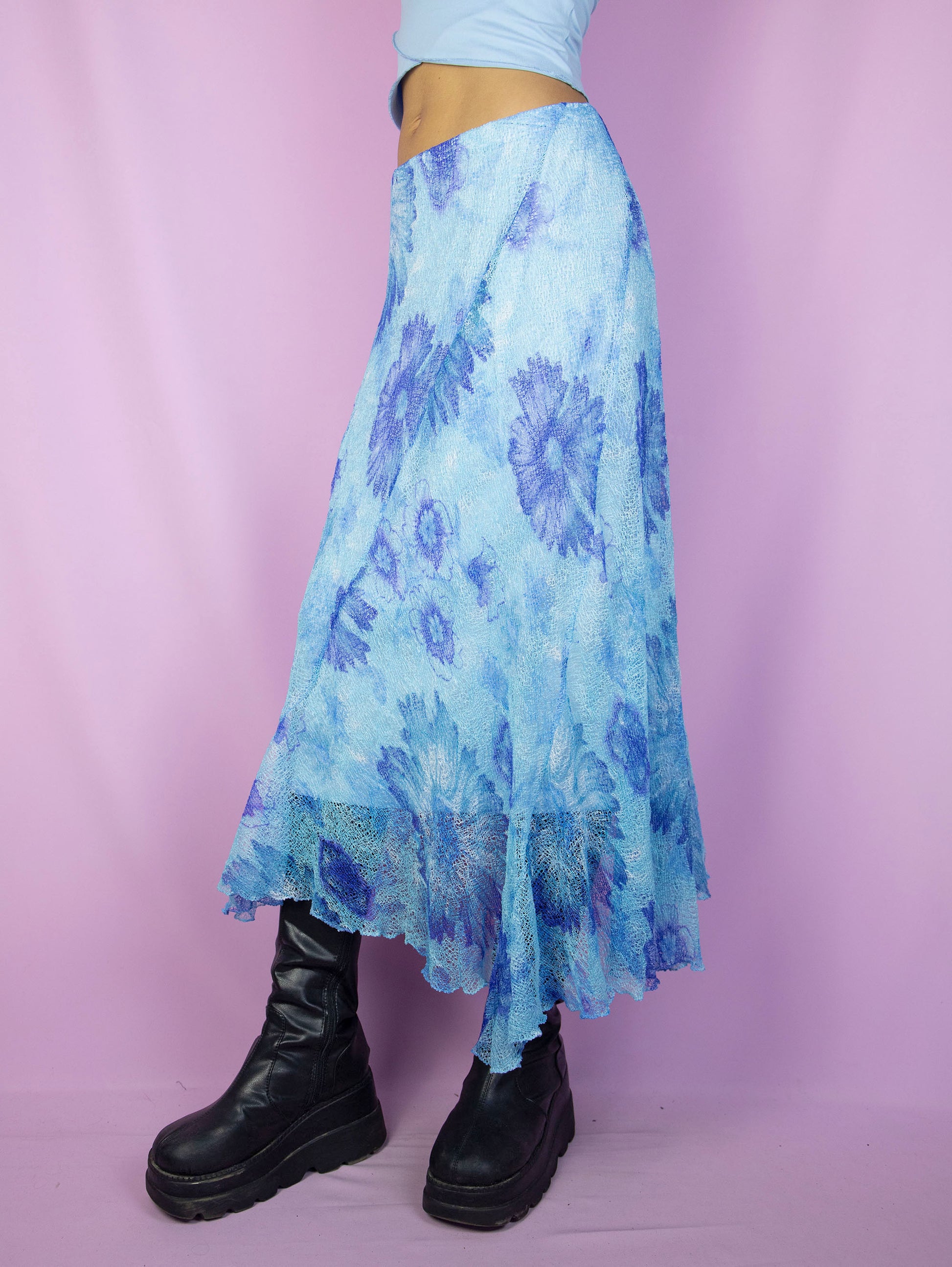 The Y2K Blue Mesh Midi Skirt is a vintage asymmetrical floral graphic skirt with an elastic waist. Boho fairy grunge 2000s summer maxi skirt.