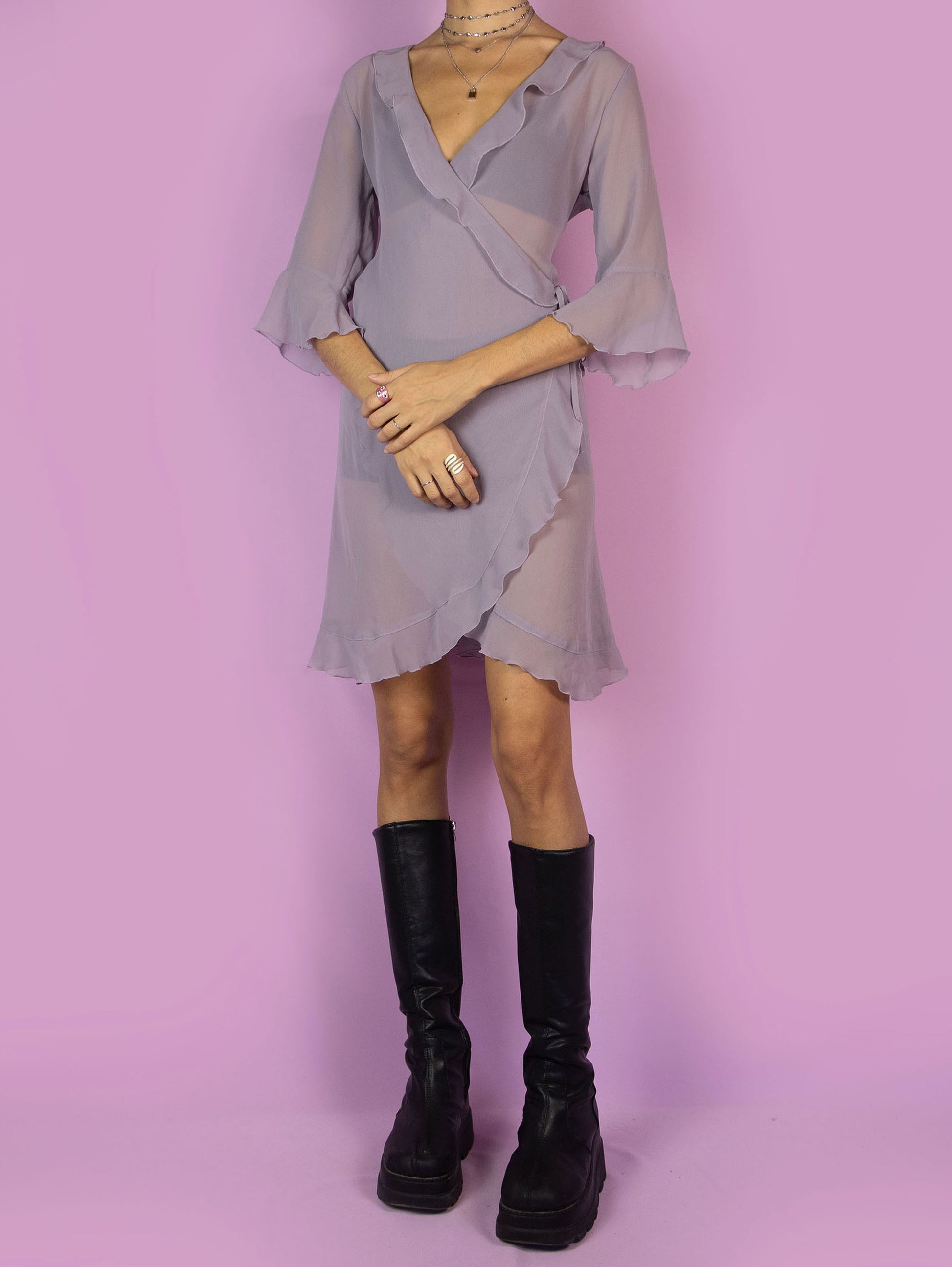 The Y2K Purple Sheer Duster Robe is a vintage dusty purple semi-transparent robe with ruffles, wrapped and tied at the side. Romantic coquette 2000s peignoir jacket.