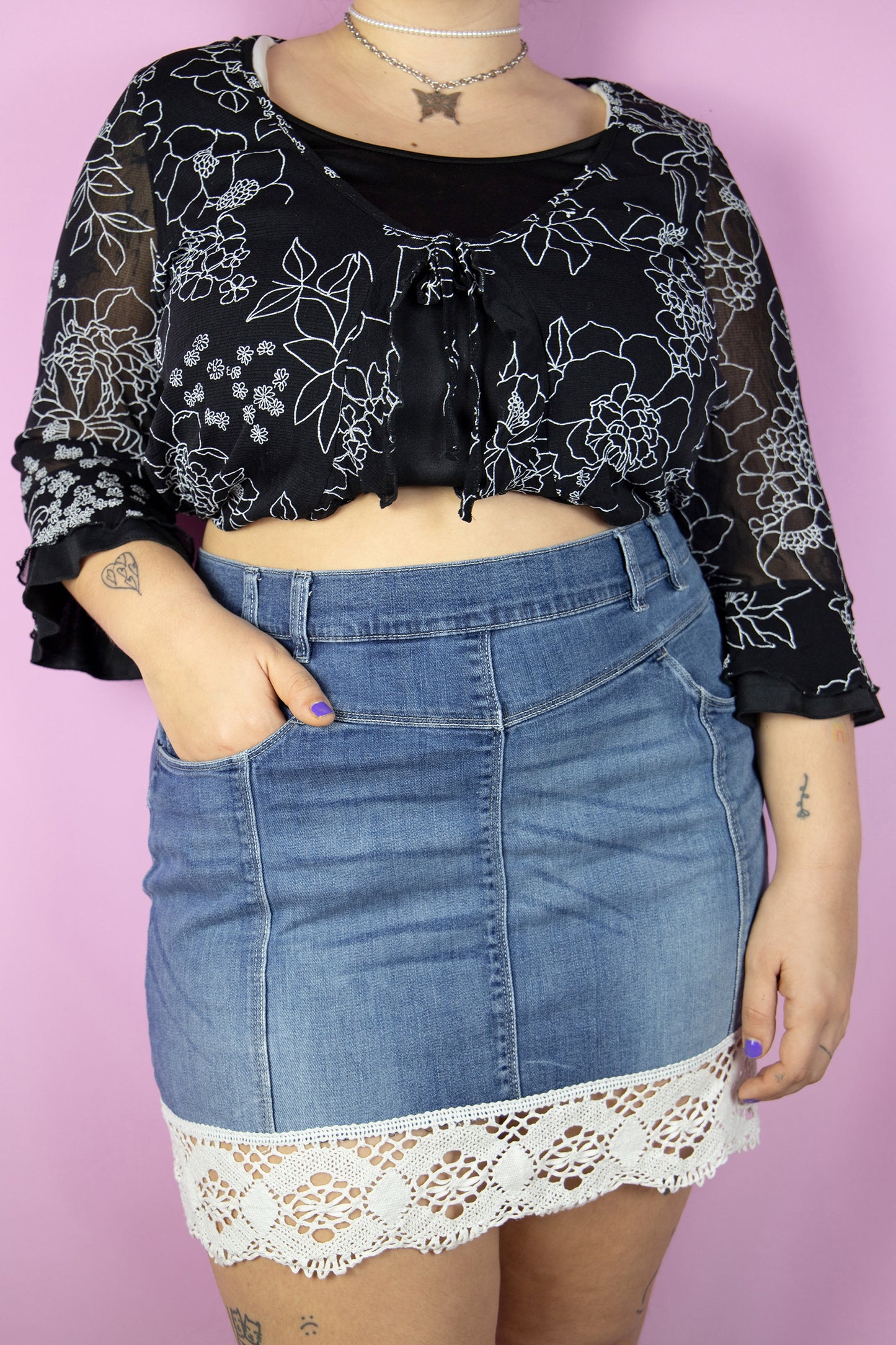 The Y2K Boho Denim Mini Skirt is a vintage stretchy skirt adorned with white crochet lace trim. Cyber 2000s summer jean mini skirt.