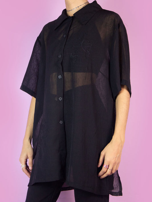 The Y2K Black Sheer Blouse is a vintage short-sleeved semi-transparent black shirt with a collar and buttons. Boho grunge 2000s summer shirt.