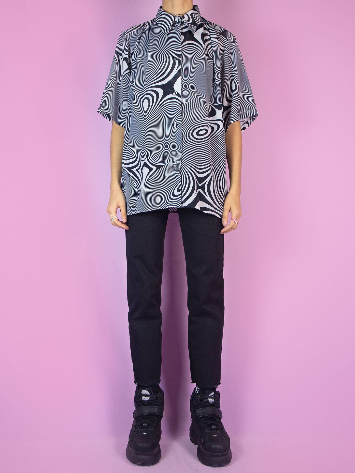The Y2K Psychedelic Swirl Graphic Shirt is a vintage black and white short-sleeved blouse with a collar and buttons. Cyber grunge 2000s festival rave summer party shirt.