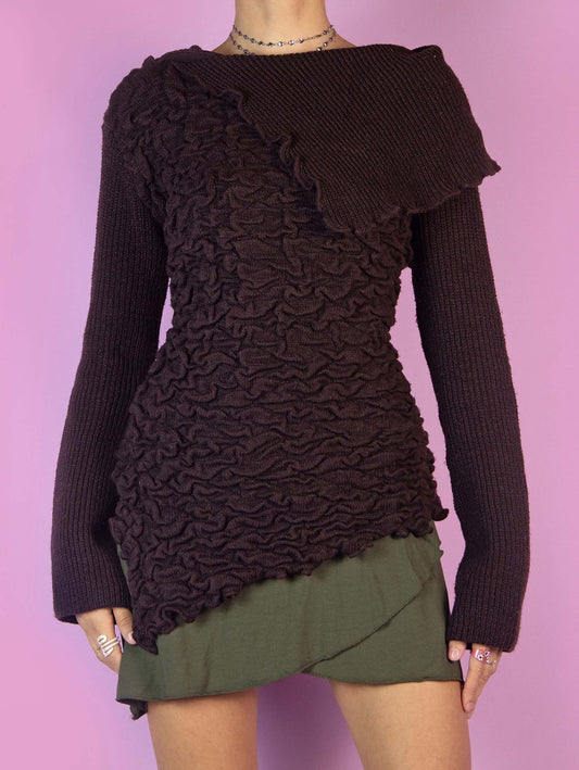 The Y2K Brown Asymmetric Knit Sweater is a vintage dark brown pullover with a pointed asymmetric hem, a textured gathered front, and a collar. Cyber fairy grunge 2000s subversive jumper.