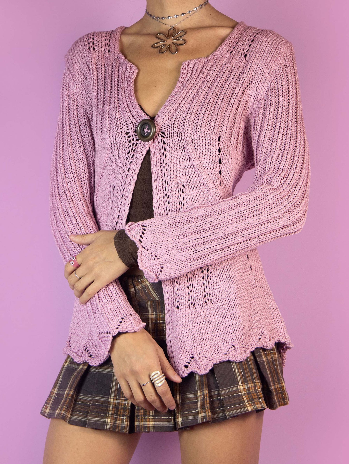 The Y2K Pink One Button Cardigan is a vintage pastel pink cardigan with a one-button closure. Boho fairy grunge 2000s crochet knit bolero jacket.