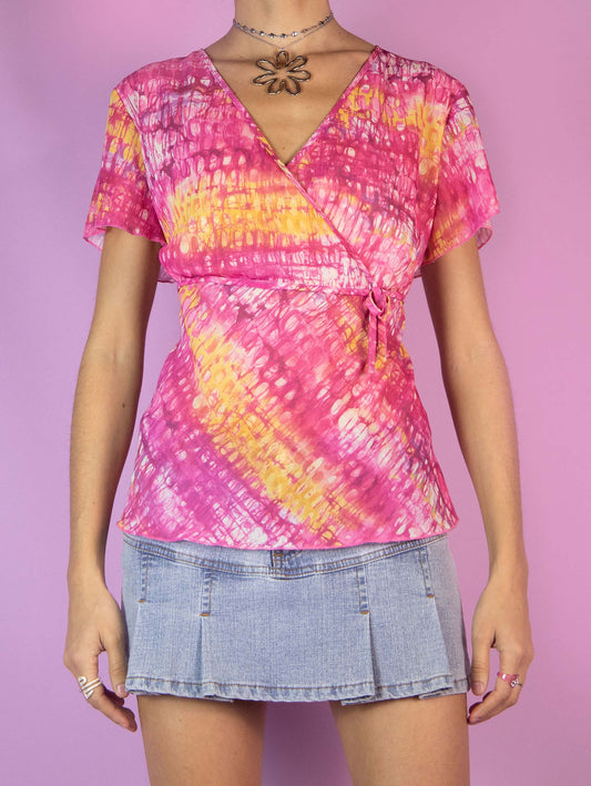 The Y2K Pink Sheer Graphic Top is a vintage short-sleeved shirt with an abstract pink and yellow tie-dye print, featuring a V-neckline. Cyber 2000s summer festival psychedelic blouse.