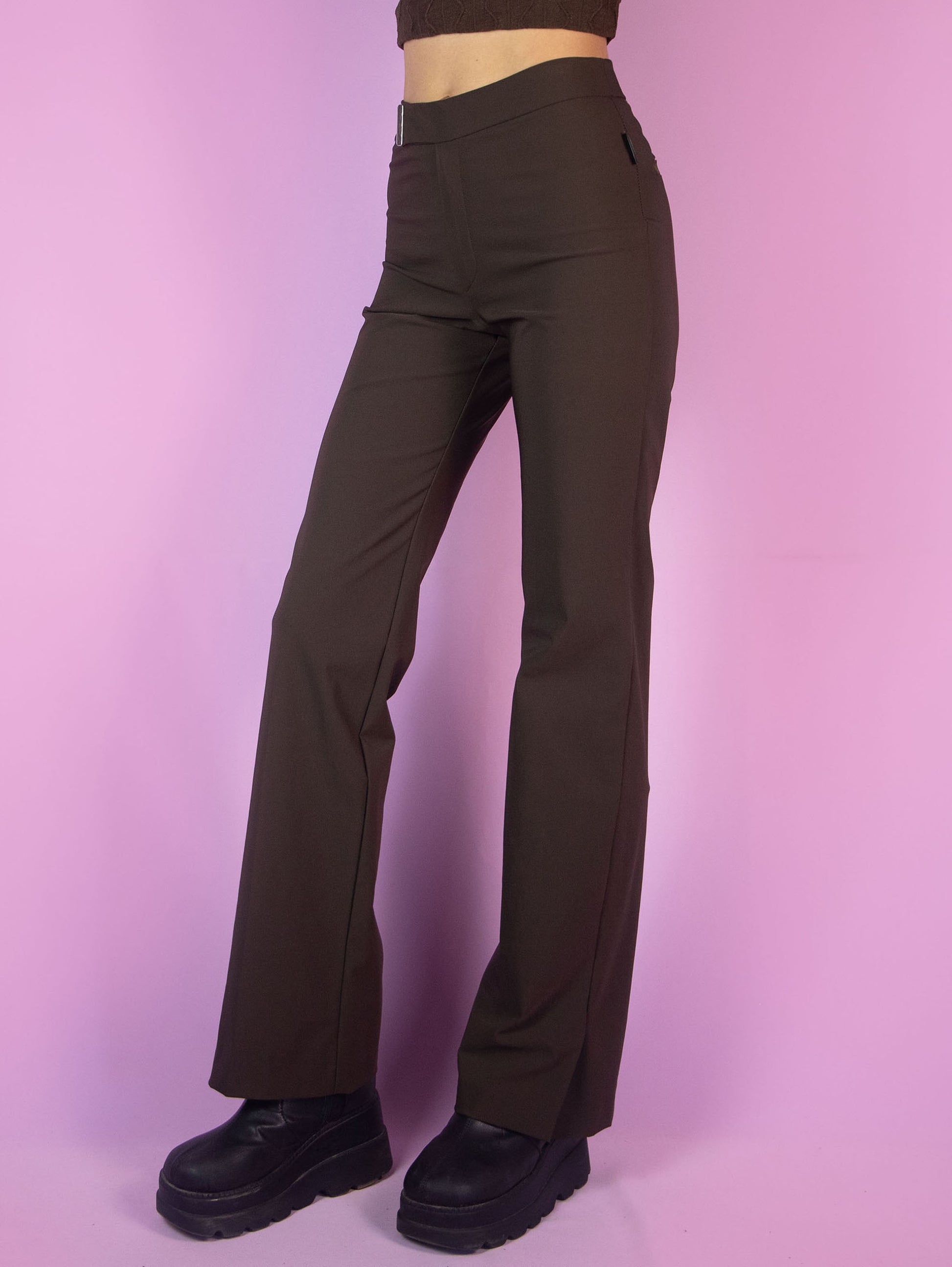 The Y2K Brown Wide Pants are vintage straight pants with elastic fabric, featuring a zipper closure and slits at the hem. Cyber grunge 2000s trousers.