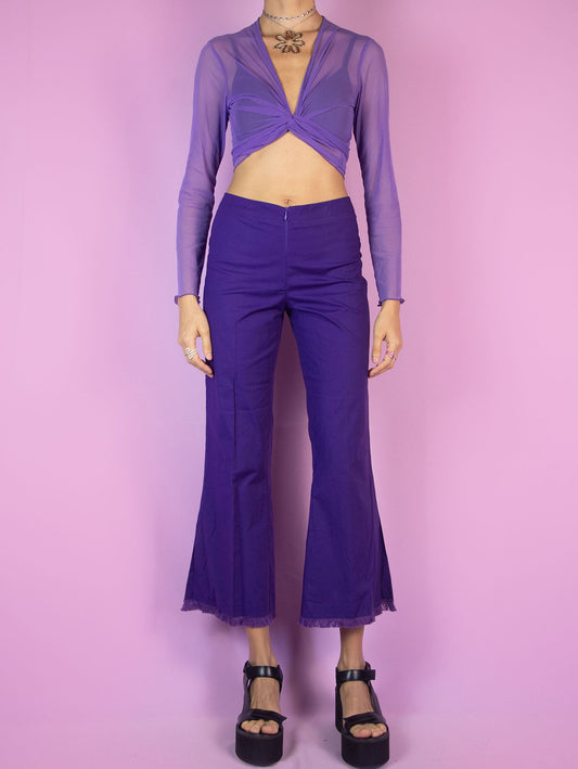 The Y2K Purple Cropped Capri Pants are vintage dark purple slightly elastic pants with a front zipper closure, featuring slits at the hem and frayed fringe. Cyber 2000s boho summer trousers.