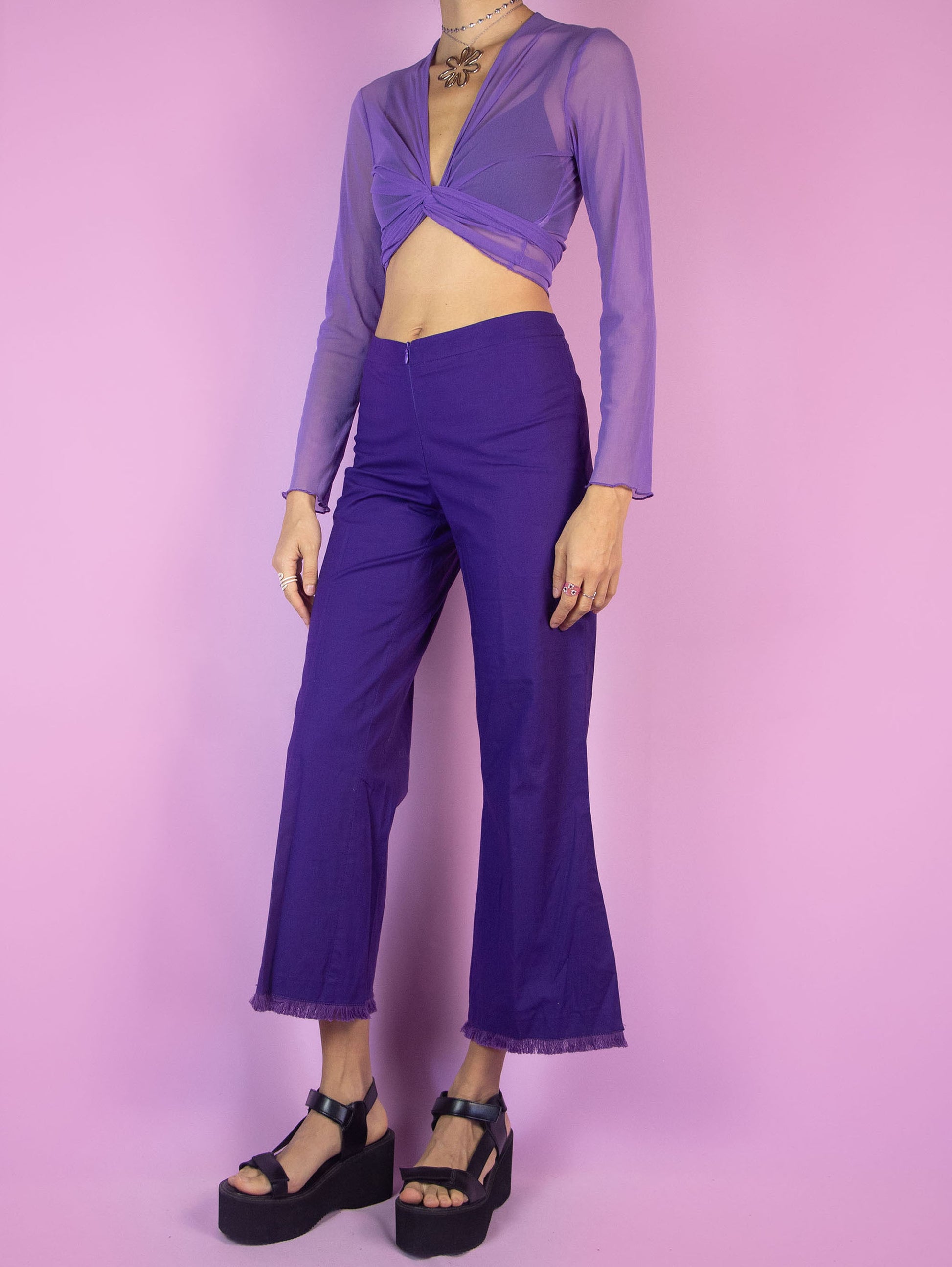 The Y2K Purple Cropped Capri Pants are vintage dark purple slightly elastic pants with a front zipper closure, featuring slits at the hem and frayed fringe. Cyber 2000s boho summer trousers.