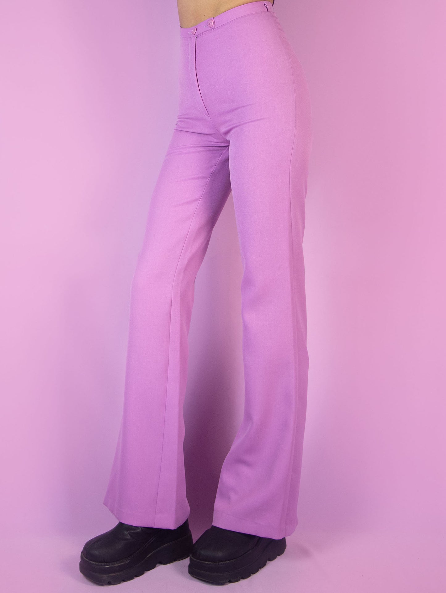 The Vintage 90s Pink Tailored Wide Pants are light pastel lilac high-waisted pants with a zipper closure and slits at the hem. Elegant evening party 1990s classic pleated trousers.