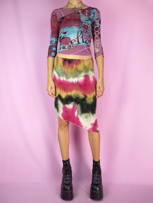 The Y2K Tie Dye Asymmetric Skirt is a vintage skirt with a multicolored ombre graphic pattern, elastic waistband, and an asymmetric pointed hem with a slit. Boho fairy grunge 2000s summer beach festival midi skirt.