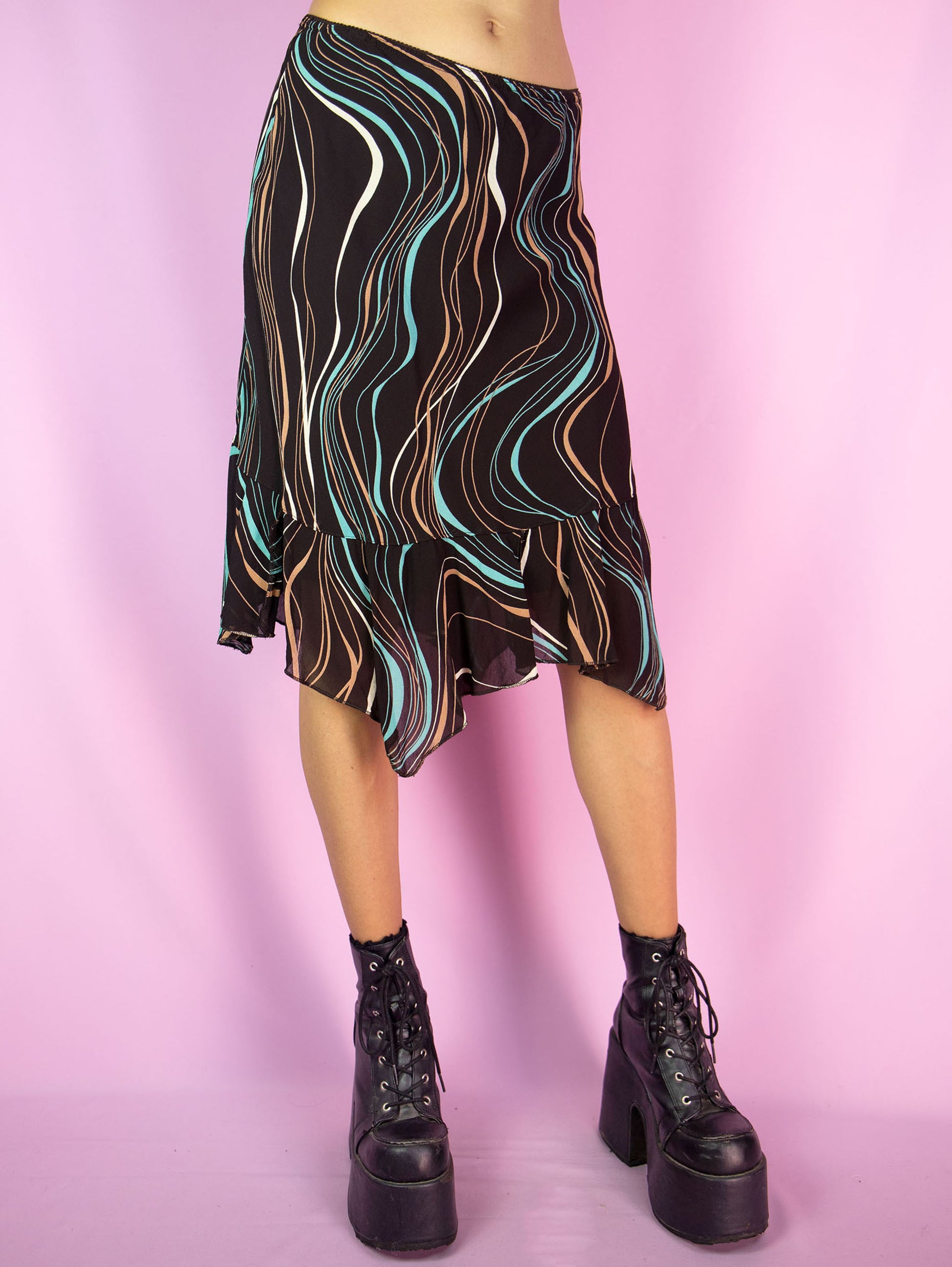 The Y2K Brown Handkerchief Mini Skirt is a vintage abstract striped printed skirt with an elasticated waist, and an asymmetrical pointed hem. Cyber fairy grunge 2000s boho summer midi skirt.
