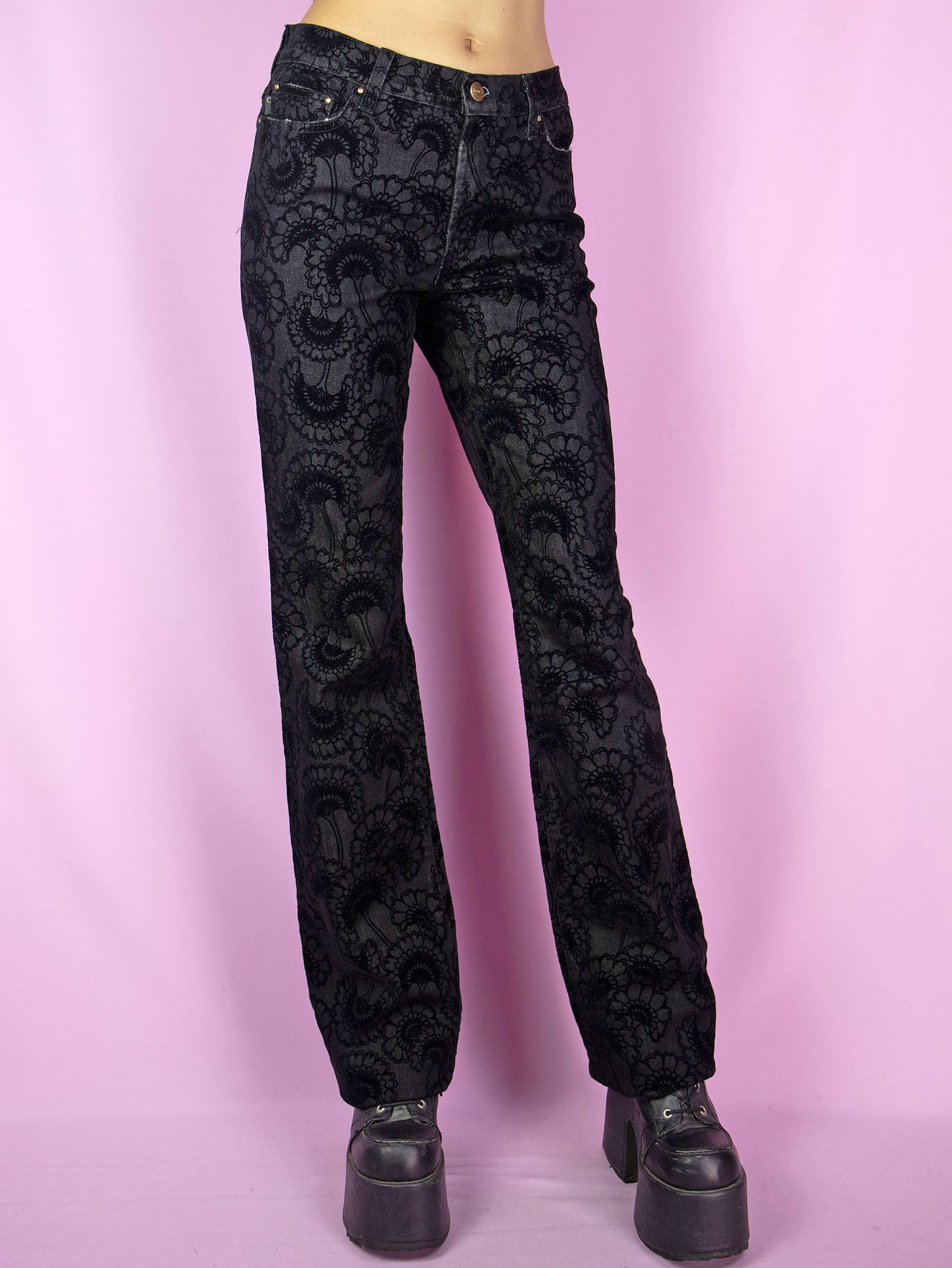 The Y2K Cavalli Black Straight Jeans are vintage 2000s mid-rise straight-leg pants, slightly stretchy adorned with floral velvet details by italian designer Roberto Cavalli. Excellent vintage condition.