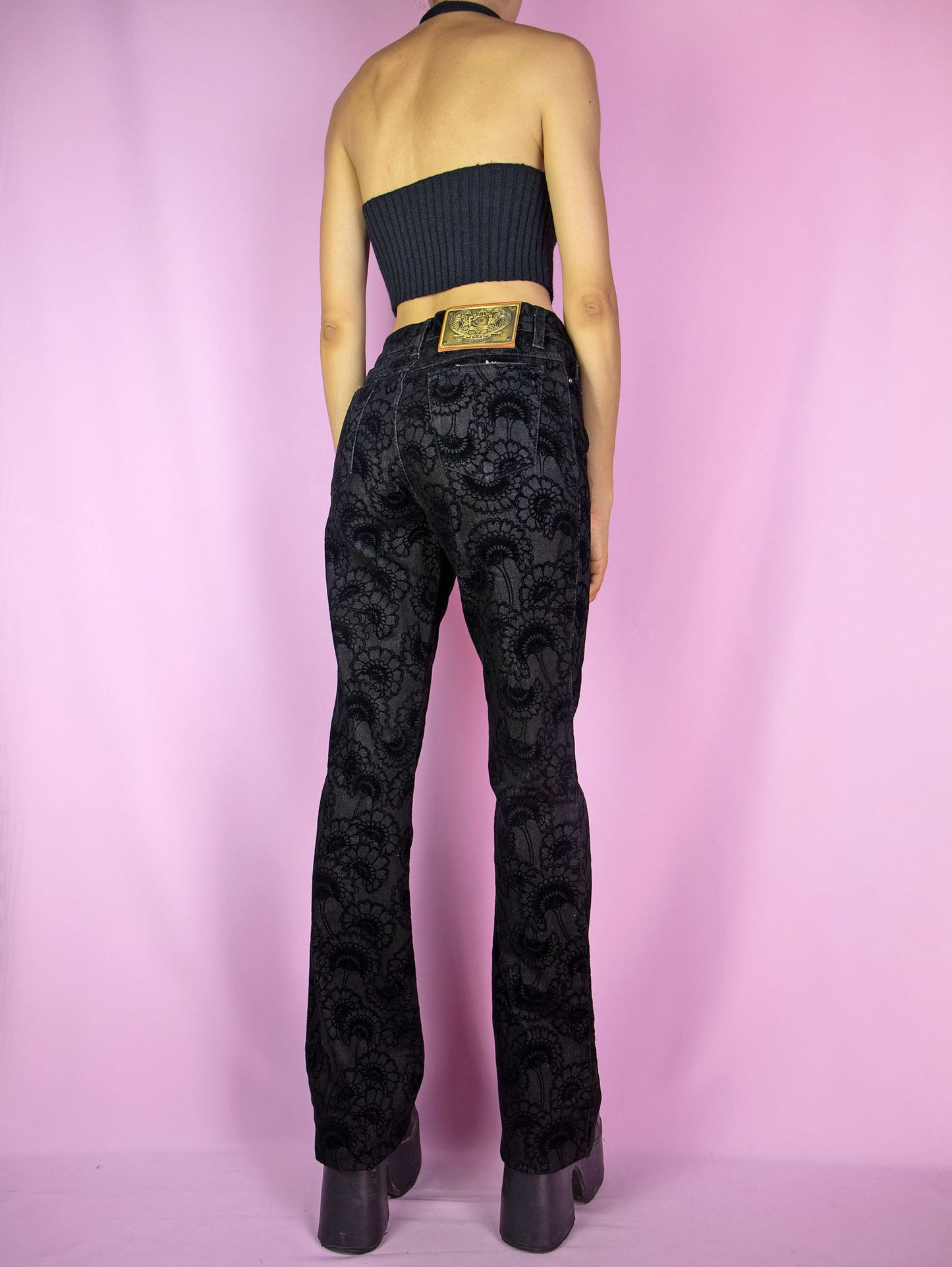 The Y2K Cavalli Black Straight Jeans are vintage 2000s mid-rise straight-leg pants, slightly stretchy adorned with floral velvet details by italian designer Roberto Cavalli. Excellent vintage condition.