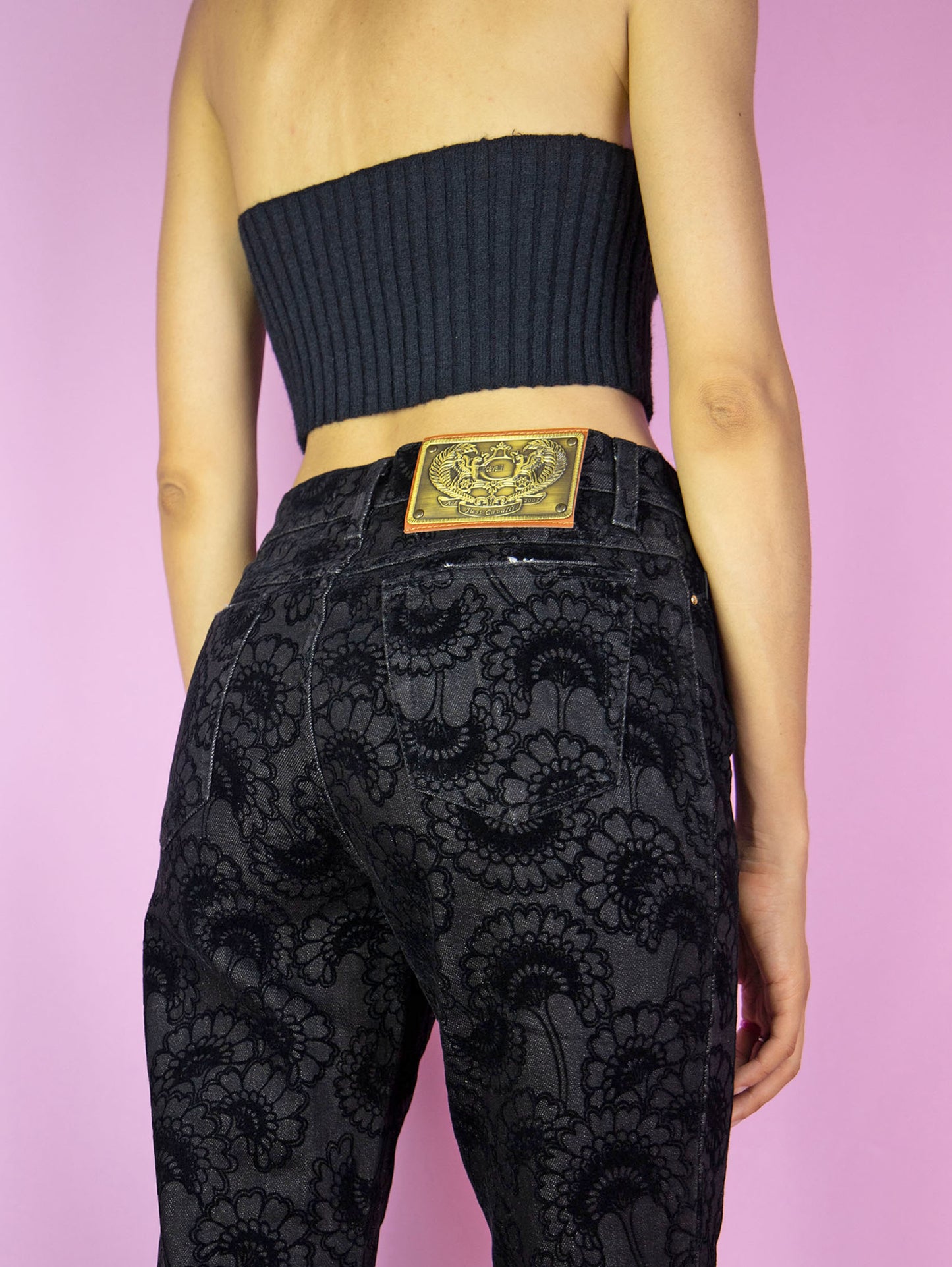 The Y2K Cavalli Black Straight Jeans are vintage 2000s mid-rise straight-leg pants, slightly stretchy adorned with floral velvet details by italian designer Roberto Cavalli. Excellent vintage condition.