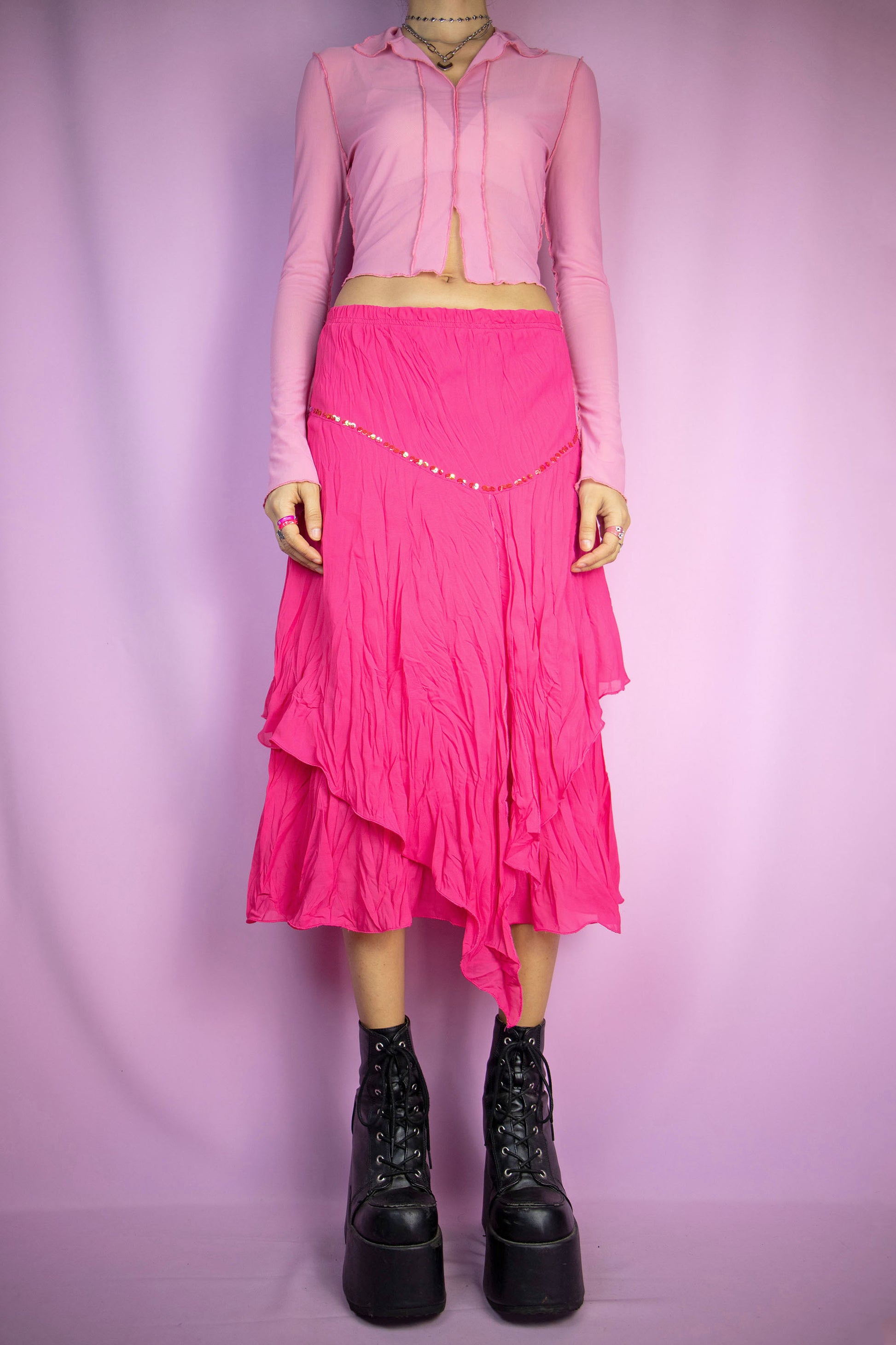 The Pink Asymmetric Midi Skirt is a vintage hot pink fuchsia layered skirt with an asymmetric pointed hem, adorned with sequin details and featuring an elasticated waist. Romantic boho fairy grunge 2000s evening party maxi skirt. Excellent vintage condition.