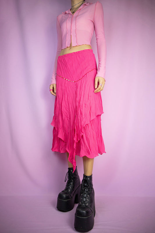 The Vintage Y2K Pink Asymmetric Midi Skirt is a hot pink fuchsia maxi skirt with an asymmetric layered design, adorned with sequin details and featuring an elasticated waist. This lovely cyber pixie fairy summer festival maxi skirt hails from the 2000s.