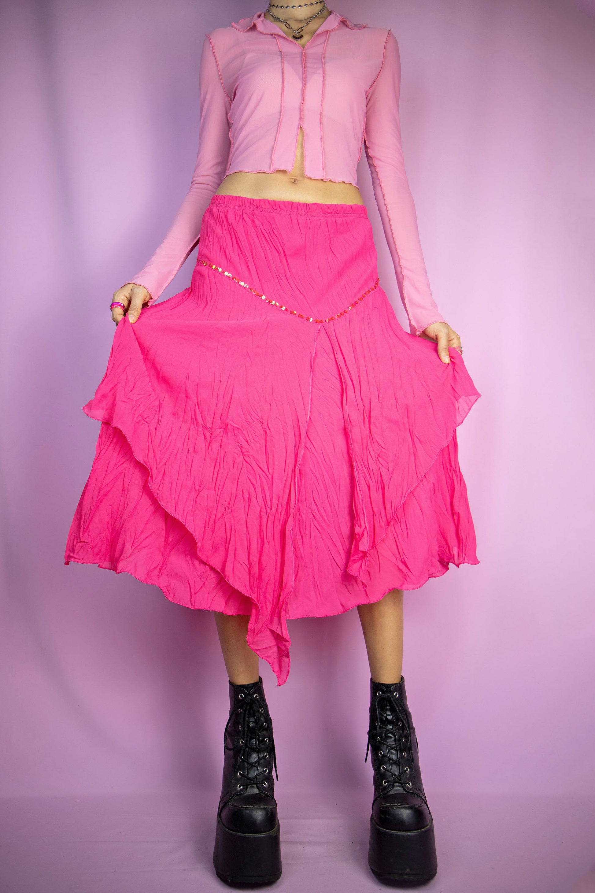 The Pink Asymmetric Midi Skirt is a vintage hot pink fuchsia layered skirt with an asymmetric pointed hem, adorned with sequin details and featuring an elasticated waist. Romantic boho fairy grunge 2000s evening party maxi skirt. Excellent vintage condition.