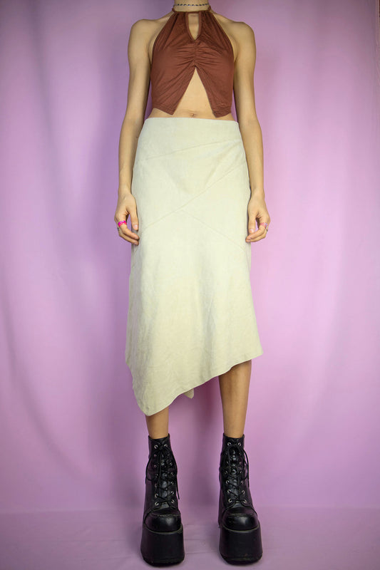 The Y2K Beige Asymmetric Midi Skirt is a vintage faux suede skirt with an asymmetrical pointed hem and a side zipper closure. Cyber fairy grunge 2000s boho maxi skirt.