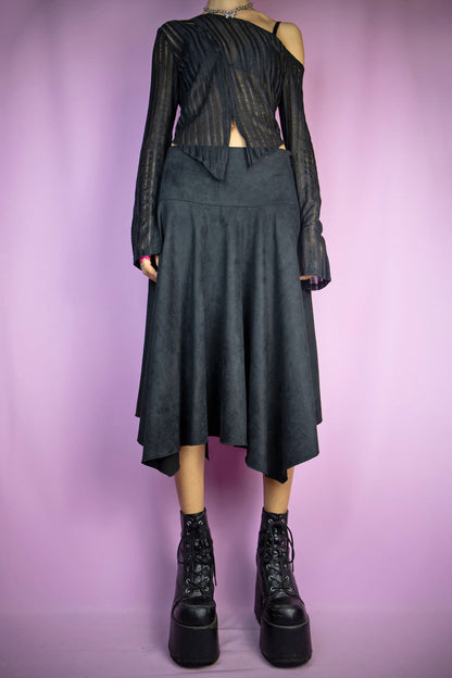 The Vintage Y2K Black Asymmetric Midi Skirt is a faux suede asymmetrical pointed long skirt with side zipper closure. Exemplifying the iconic cyber pixie fairy grunge goth style of the 2000s.