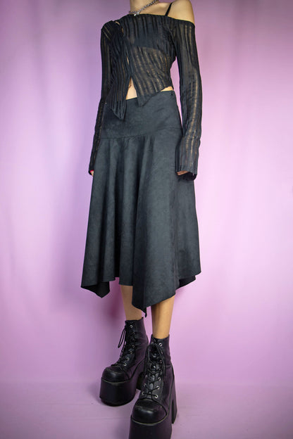 The Vintage Y2K Black Asymmetric Midi Skirt is a faux suede asymmetrical pointed long skirt with side zipper closure. Exemplifying the iconic cyber pixie fairy grunge goth style of the 2000s.