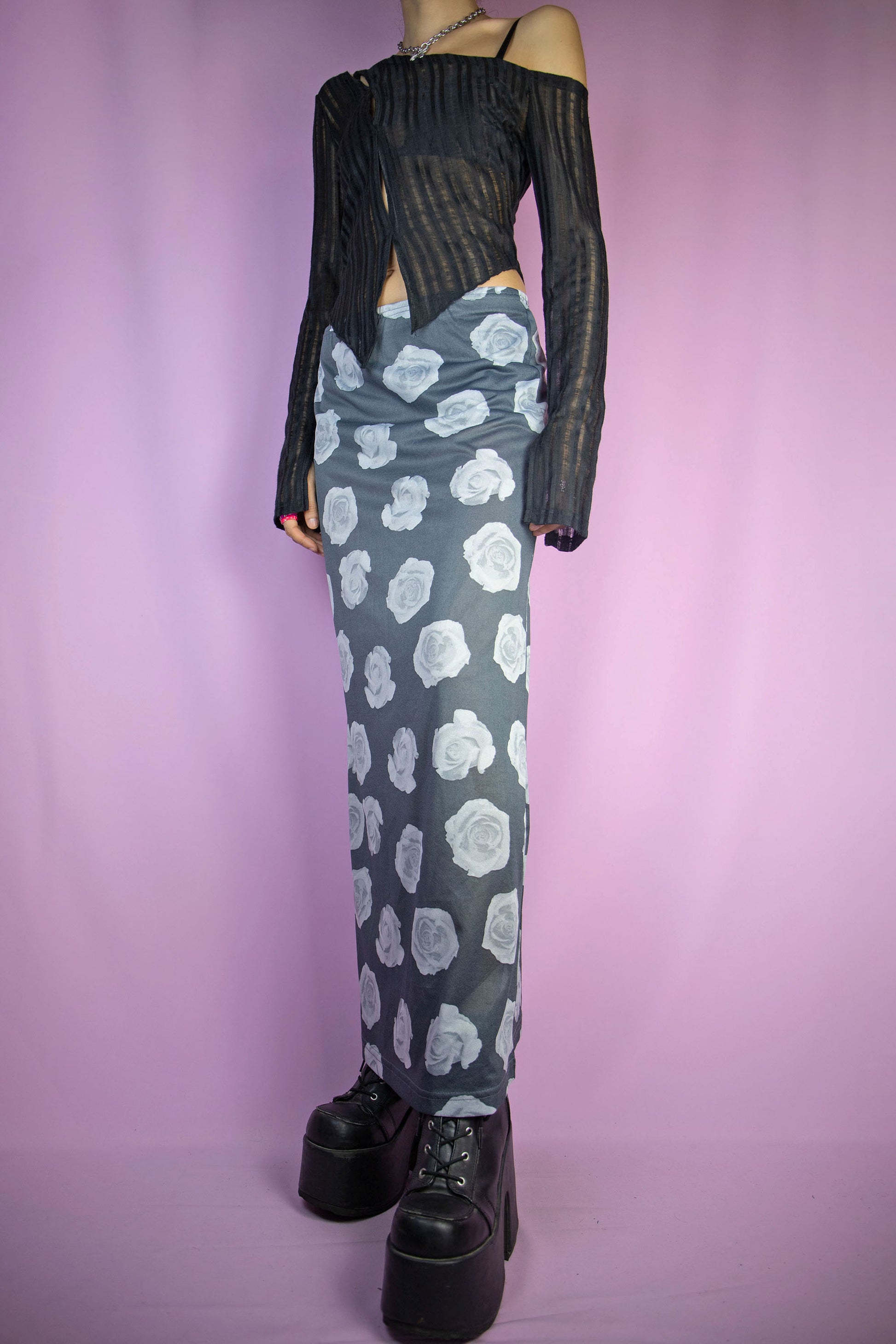 The Vintage 90s Print Sheer Midi Skirt is a semi-sheer gray rose floral graphic skirt with an elasticated waist. Boho grunge 1990s summer festival maxi skirt.