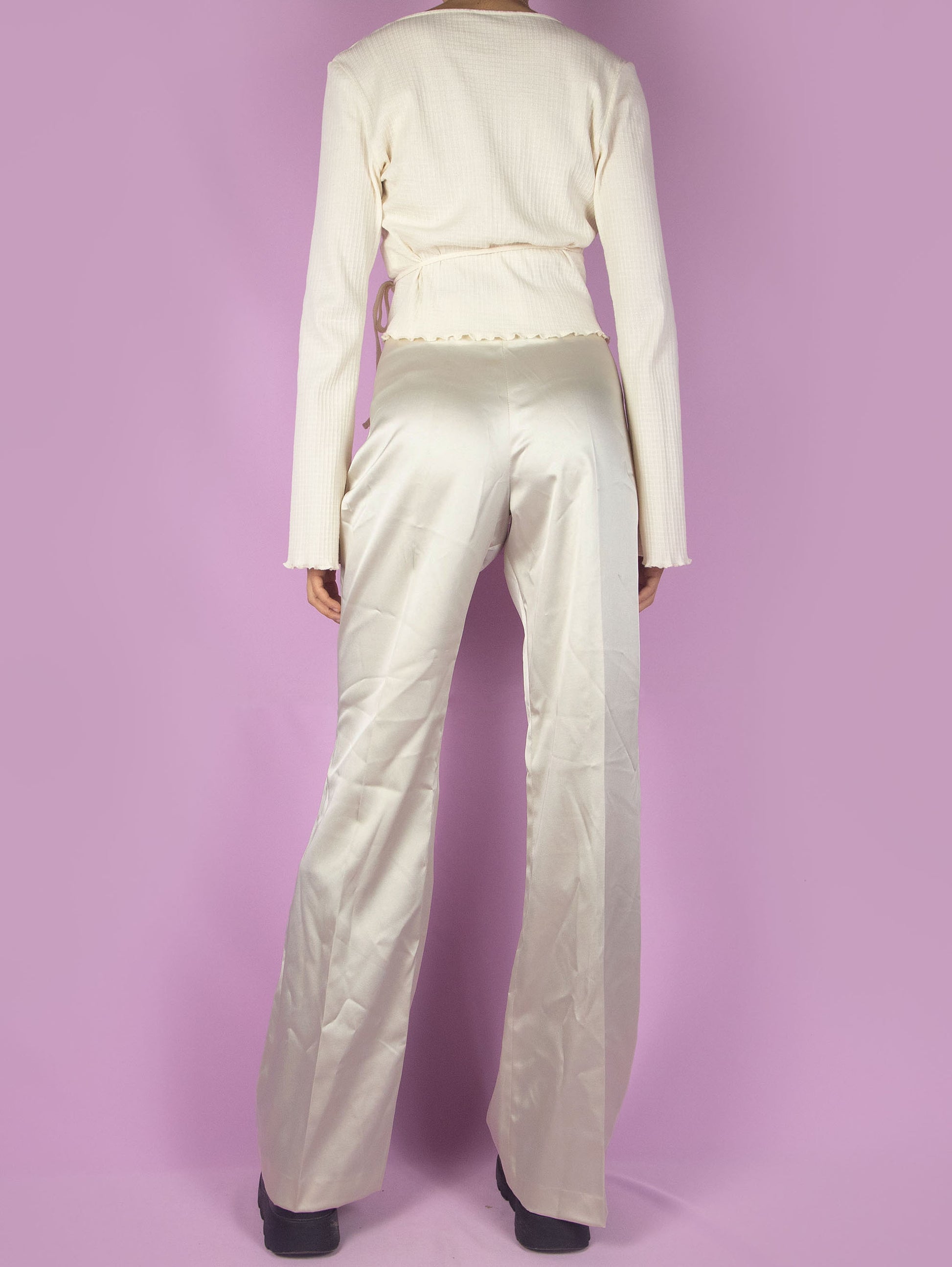 The Y2K Beige Flare Pants are vintage mid-rise shiny satin trousers, slightly elastic, with a side zipper closure. Elegant 2000s evening cocktail party trousers. Made in Italy.