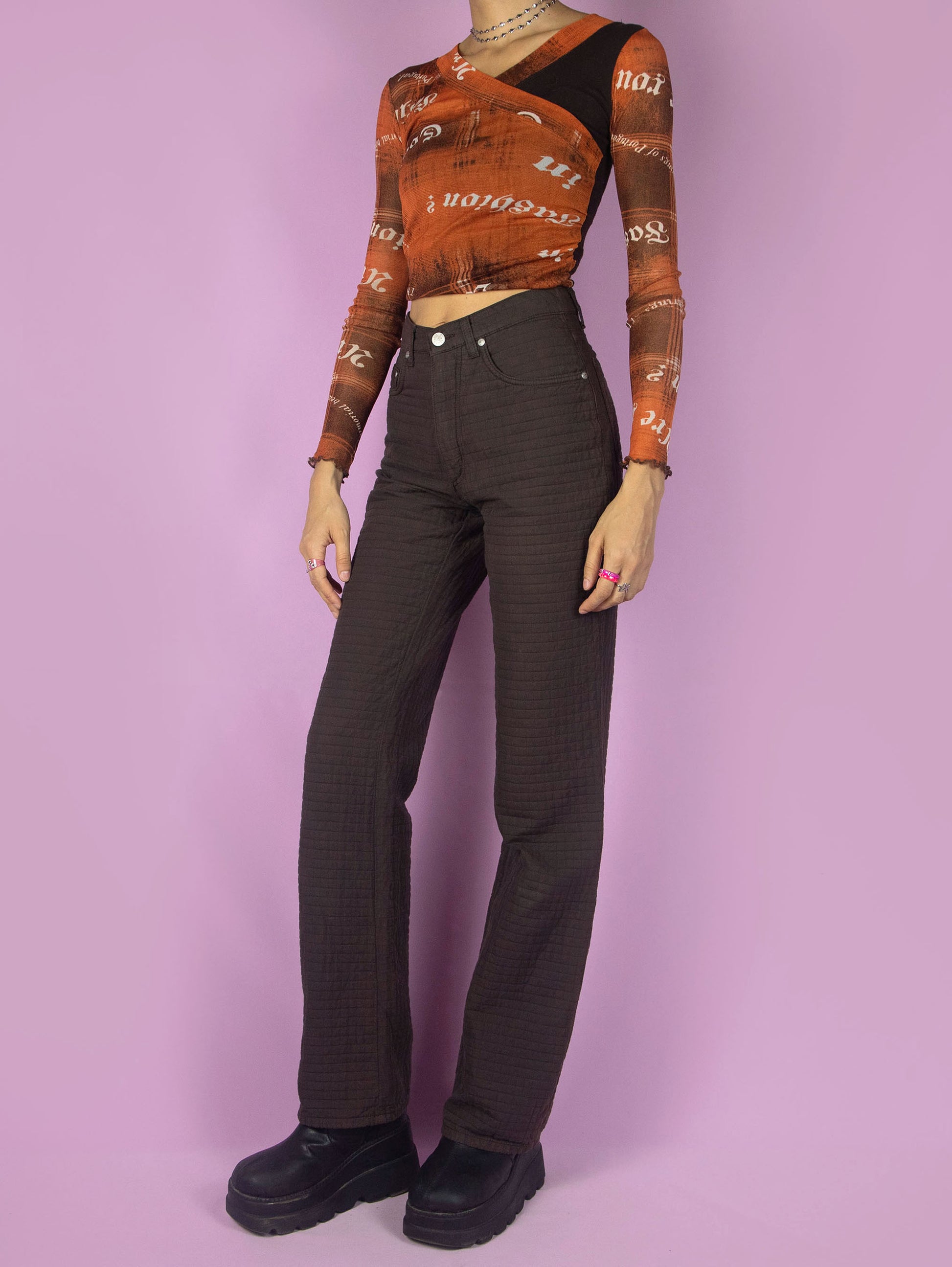 The Vintage 90s Brown Straight Leg Pants are high-waisted trousers with pockets and a front zipper closure. Made in Italy. Excellent vintage condition.