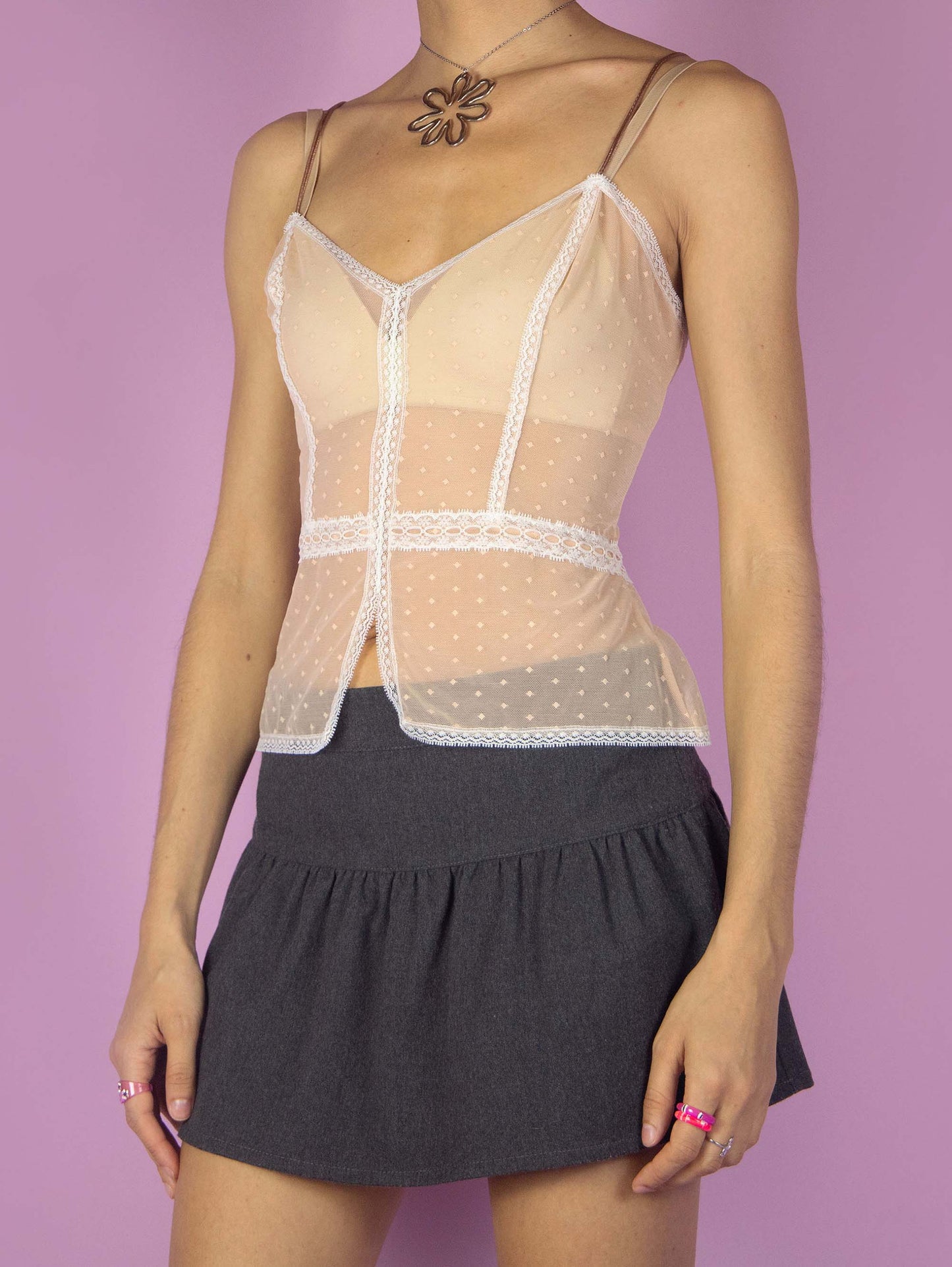 The Y2K Beige Mesh Cami Top is a vintage pink beige semi-sheer cami top with white lace details and spaghetti straps. Romantic coquette 2000s lingerie camisole. Excellent vintage condition.