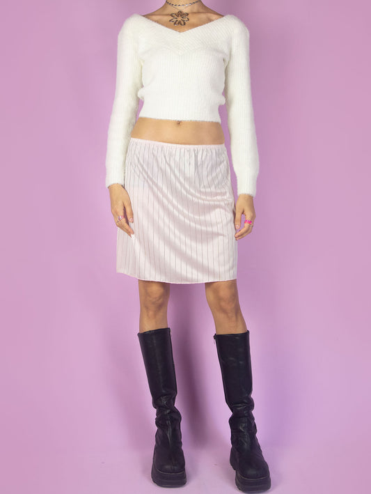 The Vintage 90s Light Pink Slip Skirt is a romantic lingerie mini skirt with an elastic waistband.