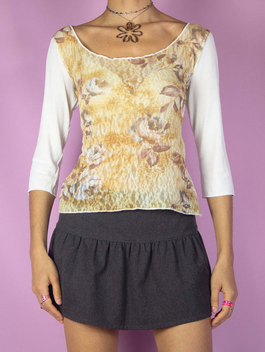 The Y2K Print Lace Mesh Top is a vintage 2000s white three-quarter sleeve knit shirt with a floral graphic lace front.