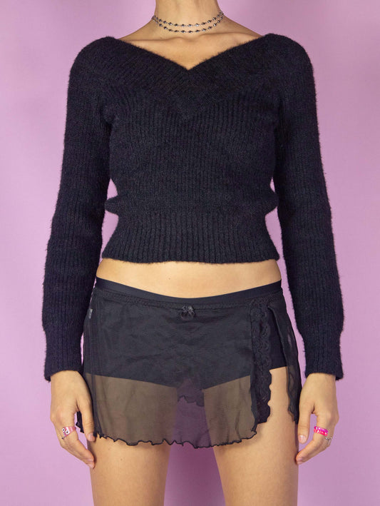 The Vintage 90s Black Mesh Mini Skirt is a semi-sheer micro skirt with a side slit adorned with lace details, and an elastic waistband. Romantic 1990s lingerie slip skirt.