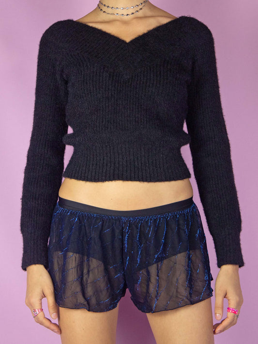 The Vintage 90s Black Sheer Lingerie Shorts are shiny shimmering black and blue metallic transparent shorts with an elastic waistband. Made in Spain. Excellent vintage condition.