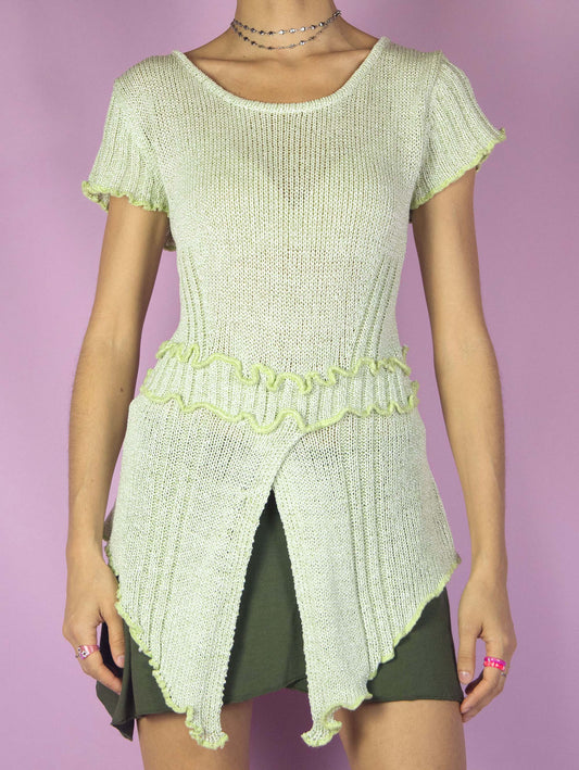 The Y2K Asymmetric Knit Fairy Top is a short-sleeved pastel light green knit shirt with a pointed hem and seam detail. Boho grunge 2000s festival rave party top. Made in Spain.