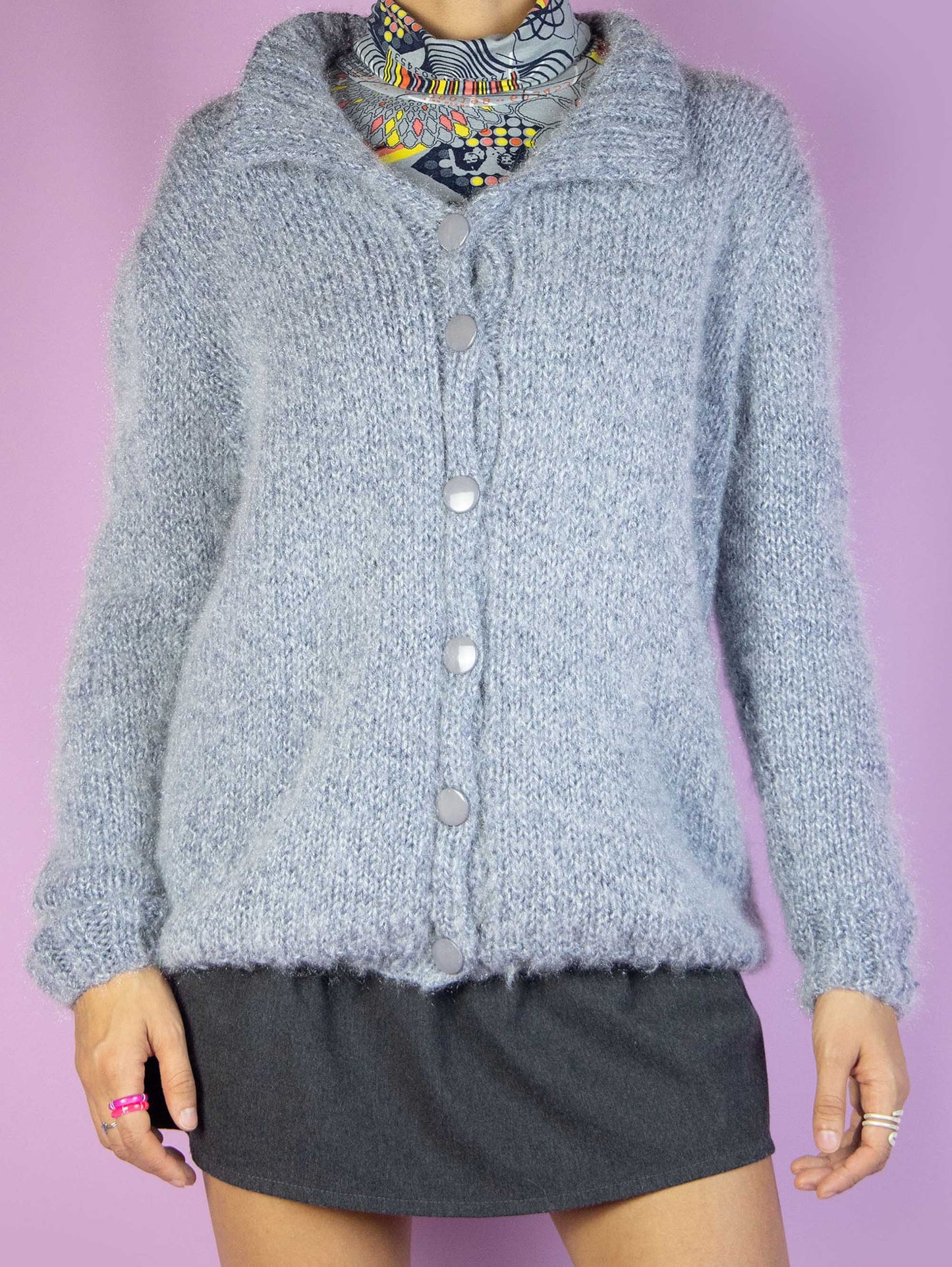 The Y2K Gray Knit Cardigan is a vintage 2000s winter fluffy knit cardigan sweater with a collar and buttons.