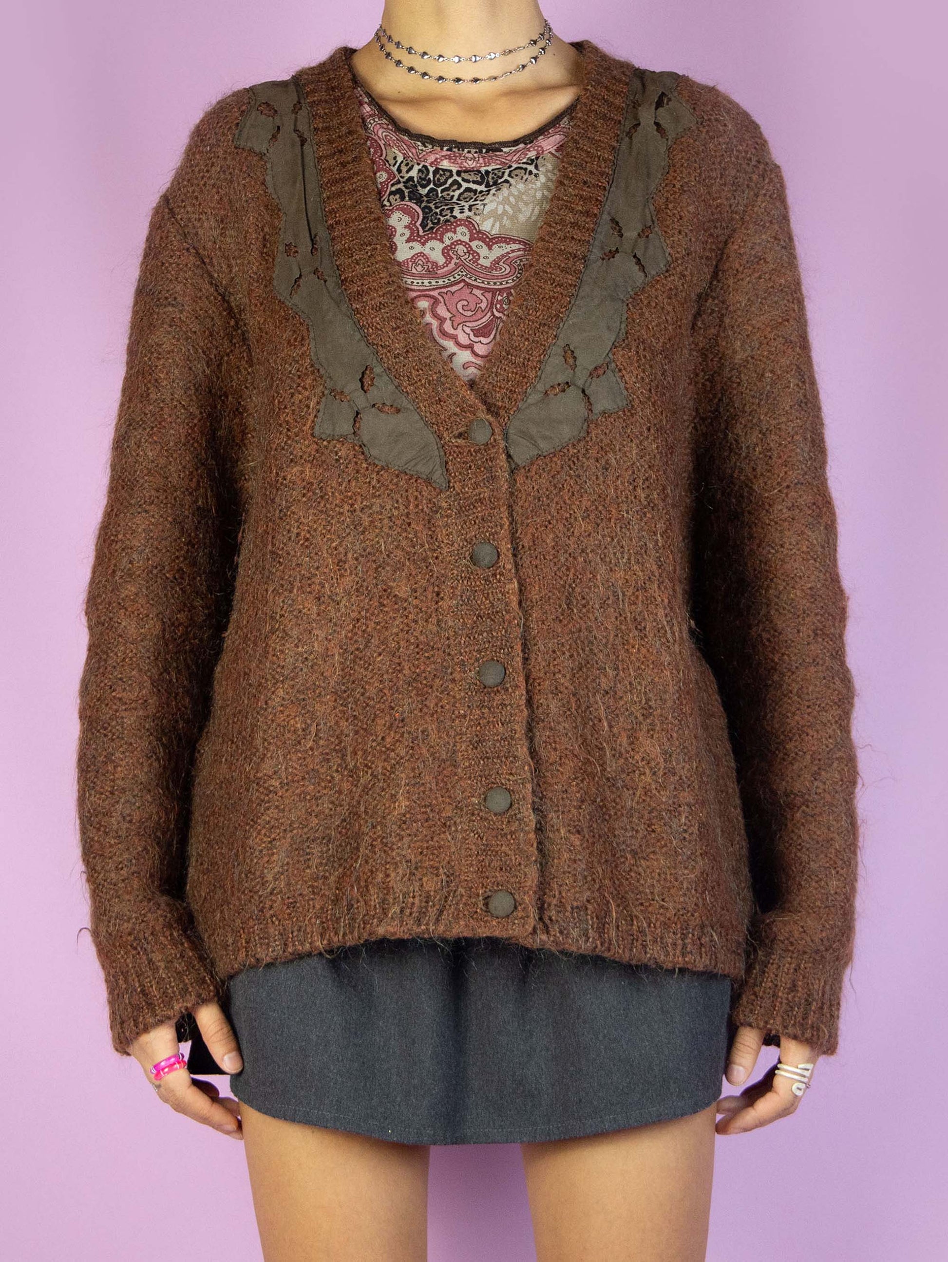 The Vintage 90s Brown Knit Cardigan is a winter V-neck cardigan sweater with buttons.