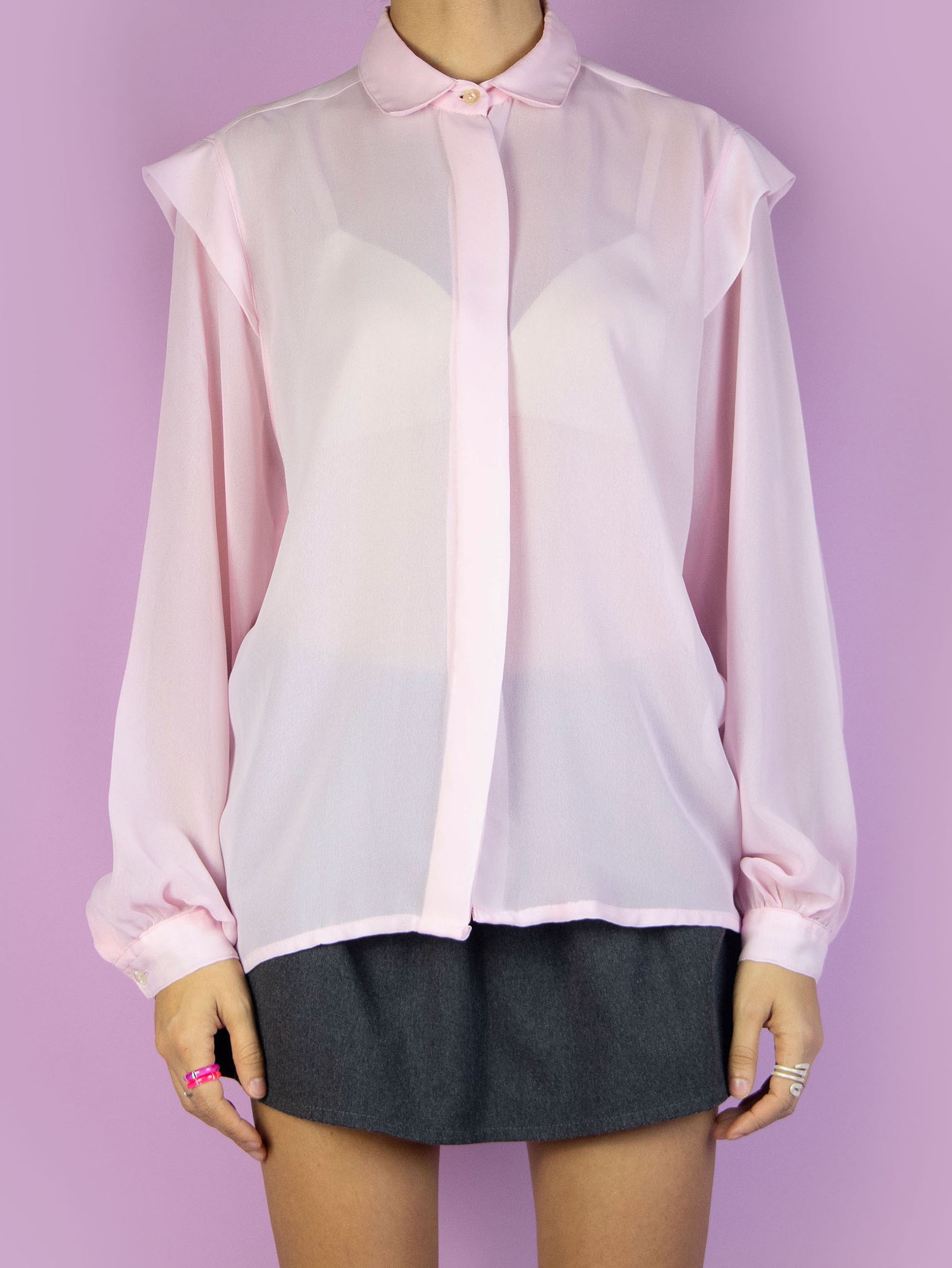 The Vintage 90s Pink Sheer Romantic Blouse is an elegant preppy coquette pastel light pink shirt with a collar and button closure.