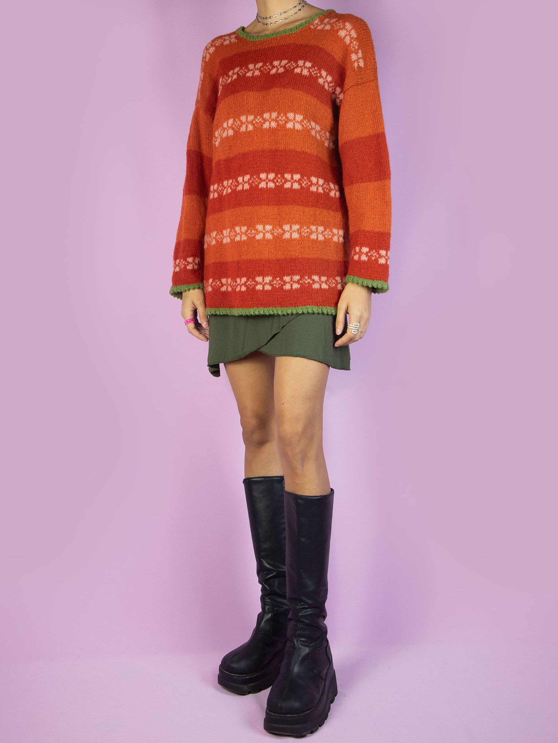 The Vintage 90s Orange Striped Sweater is a winter multicolored orange, white, and green striped pullover.
