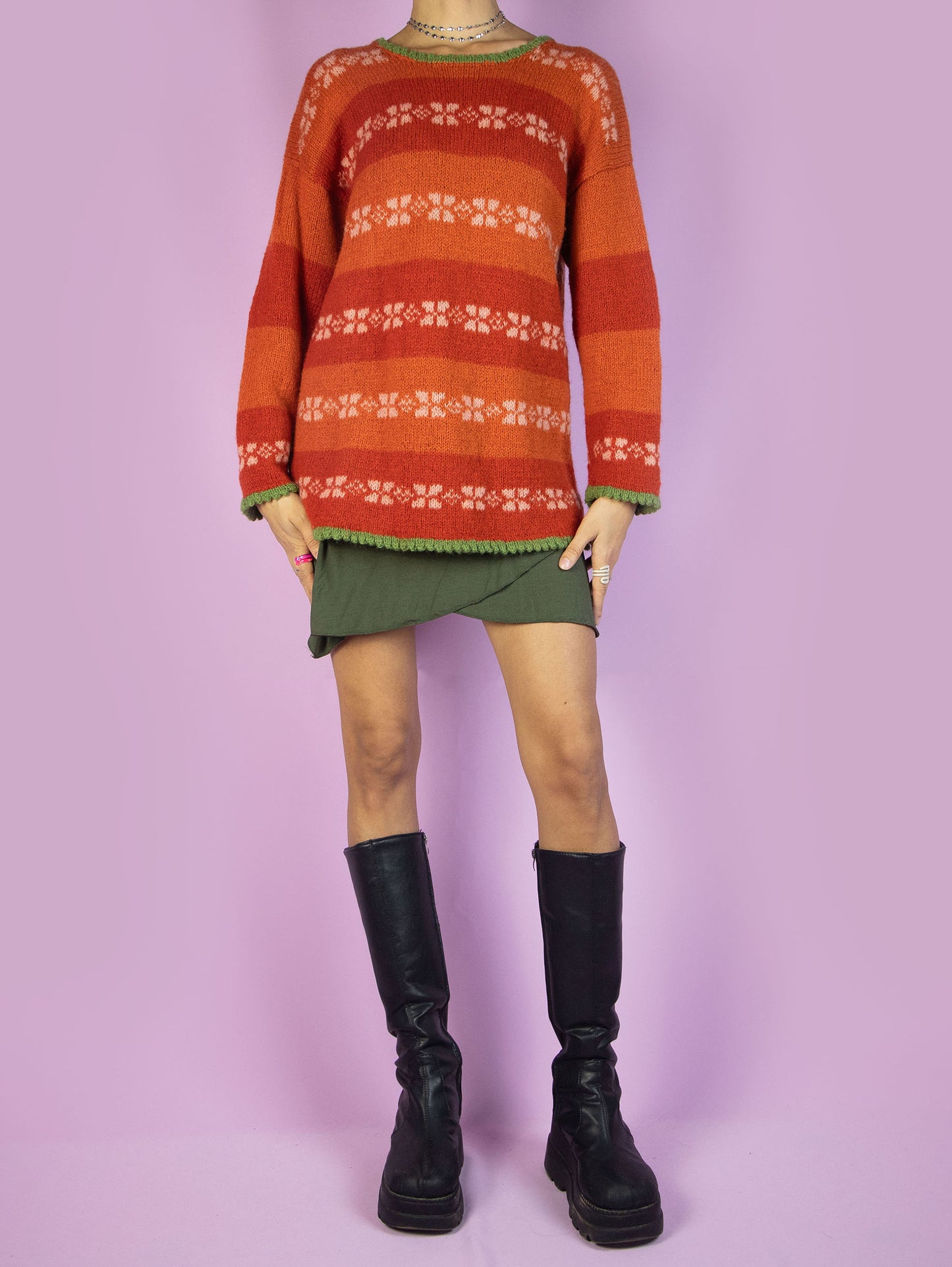 The Vintage 90s Orange Striped Sweater is a winter multicolored orange, white, and green striped pullover.