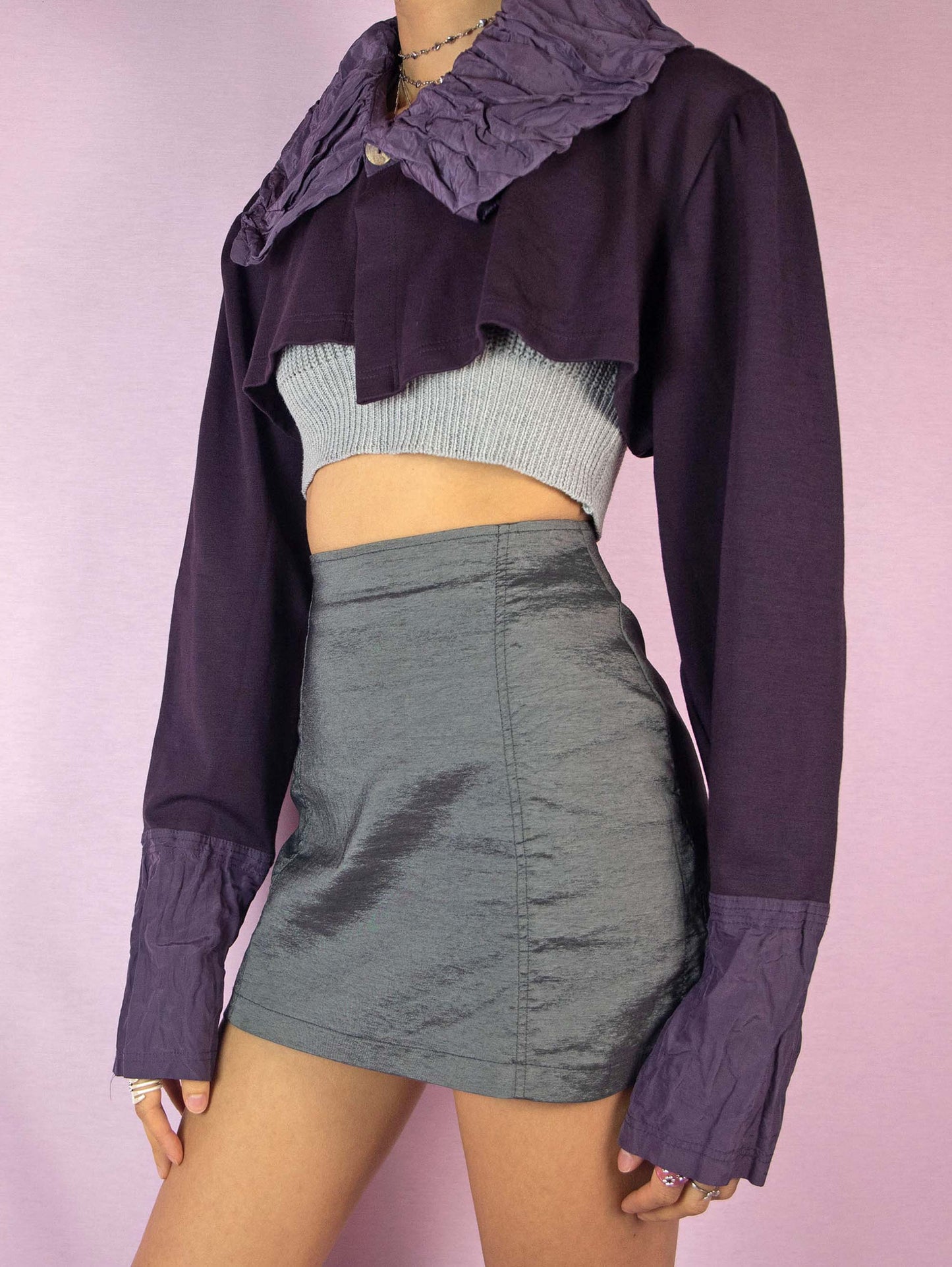 The Y2K Dark Purple Bolero Jacket is a vintage 2000s deconstructed subversive avant-garde party cropped jacket featuring a collar and a one-button closure. Made in Italy.