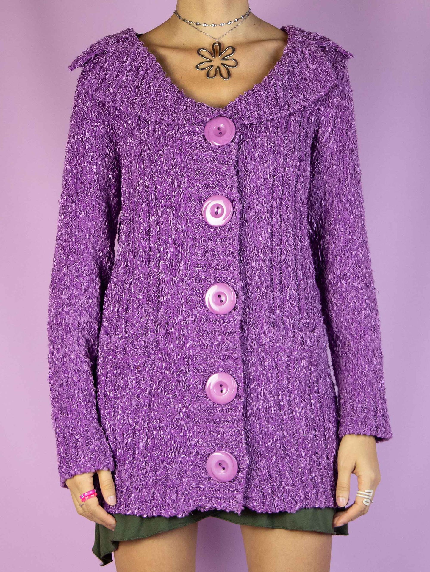The Y2K Purple Knit Cardigan is a vintage 2000s winter chunky knit cardigan sweater with a collar, pockets, and big buttons.