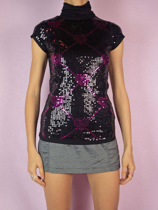The Y2K Black Sequin Turtleneck Top is a vintage 2000s short-sleeved party shirt with a high neck embellished with black and pink sequins in a heart pattern.