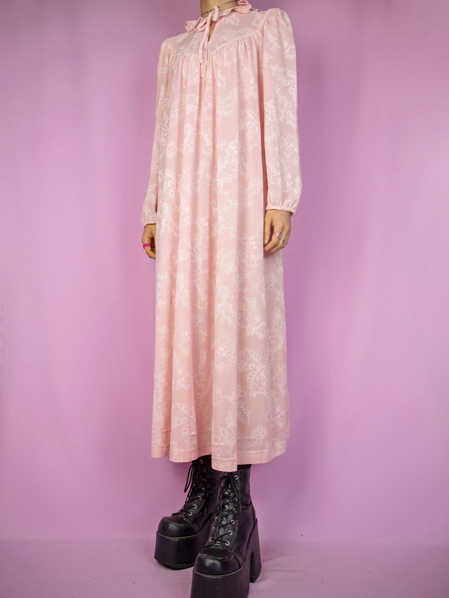 The Vintage 90s Pink Nightgown Dress is a pastel pink floral long sleeve midi dress with a tied-up front ruffle neckline. Lovely romantic sleepwear 1990s night dress.