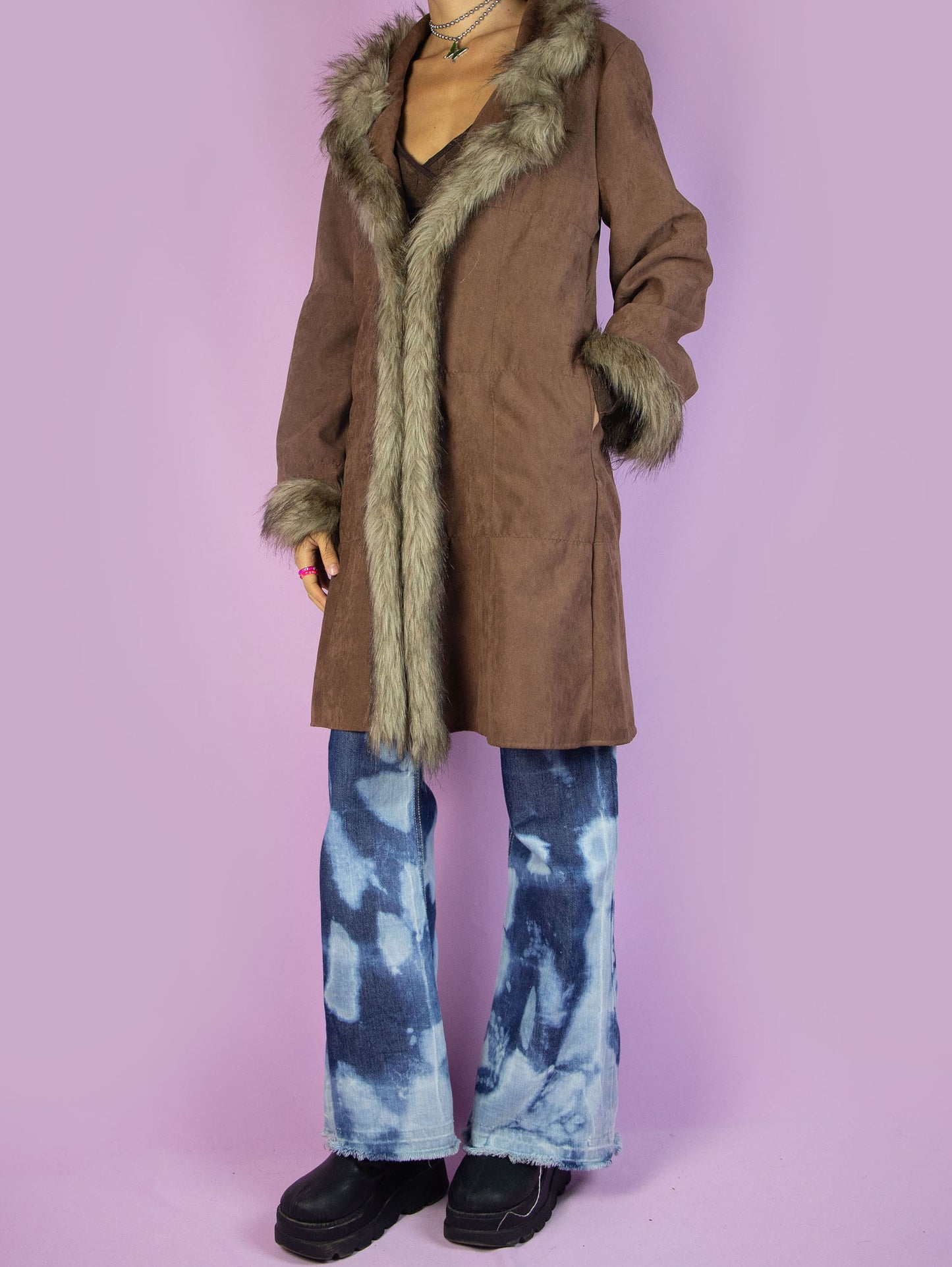 The Y2K Brown Penny Lane Coat is a vintage 2000s afghan-inspired faux suede statement jacket with faux fur collar and cuffs, featuring pockets and a tied front.