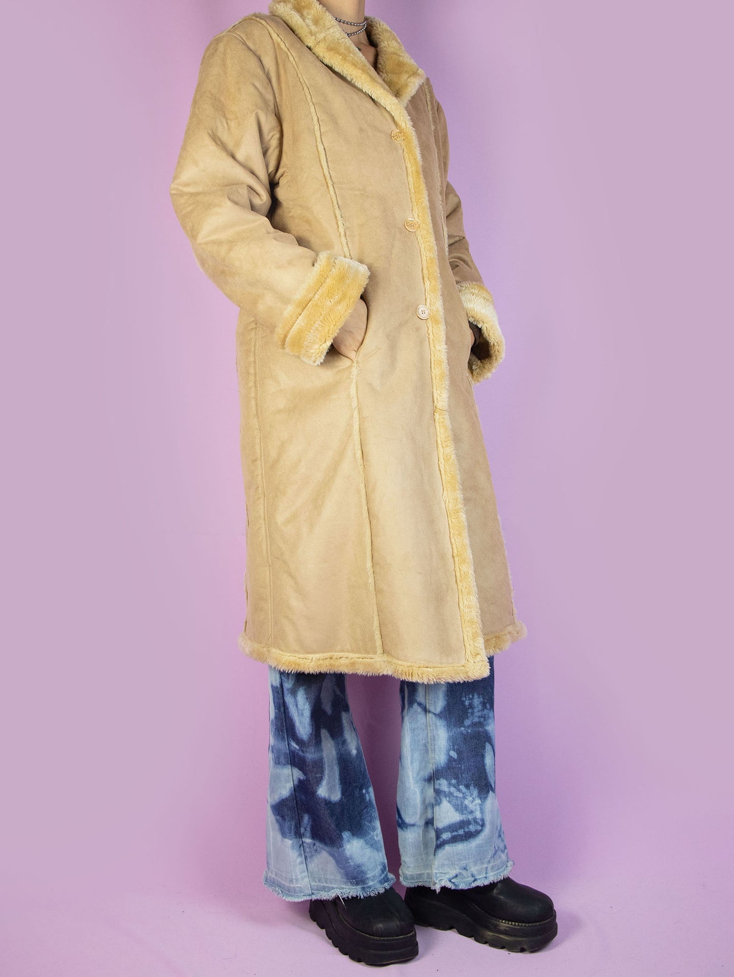 The Y2K Winter Suede Maxi Coat is a vintage 2000s light beige-brown faux suede long statement jacket with faux fur interior, collar, cuffs, pockets, and buttons.