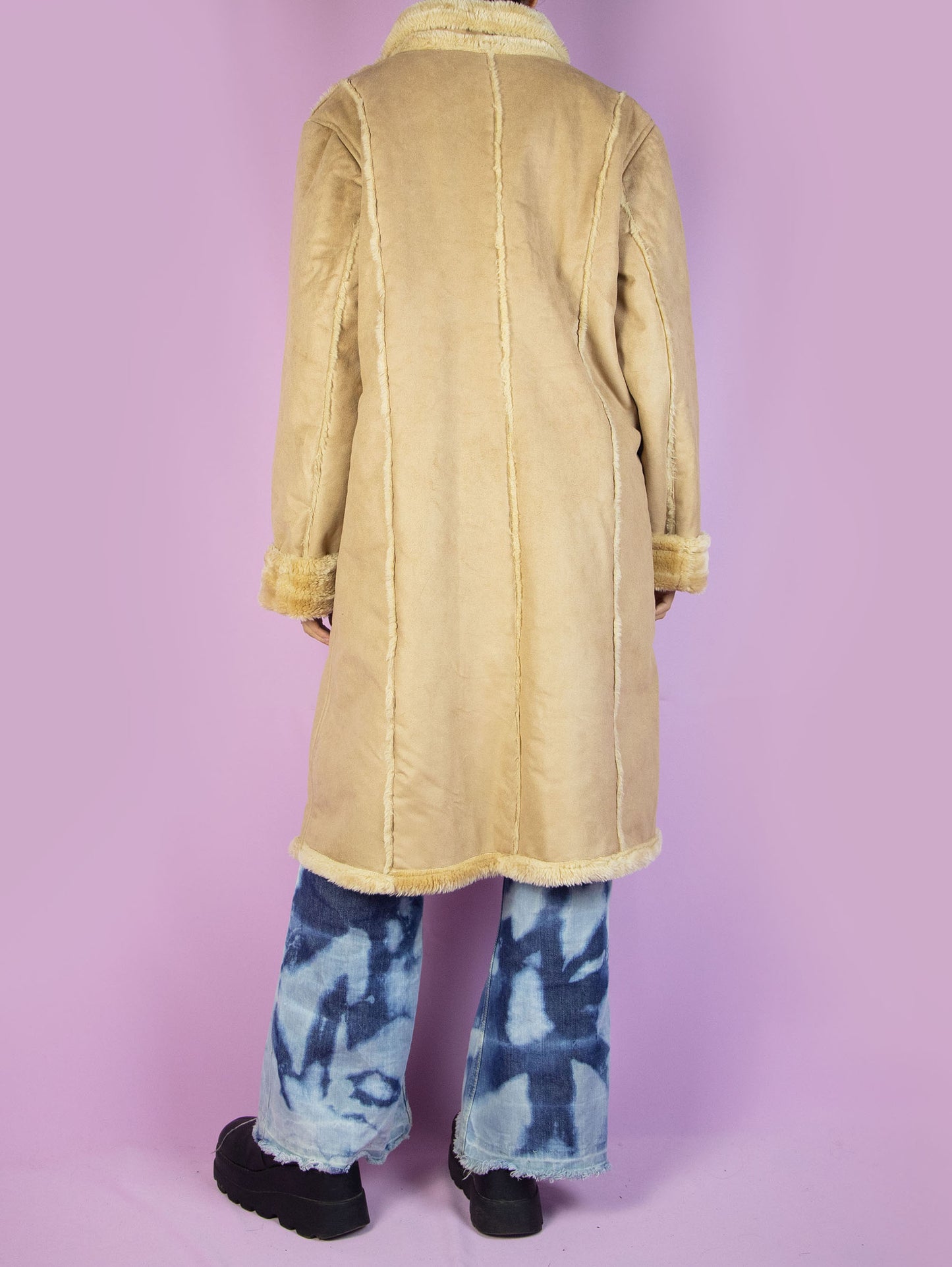 The Y2K Winter Suede Maxi Coat is a vintage 2000s light beige-brown faux suede long statement jacket with faux fur interior, collar, cuffs, pockets, and buttons.