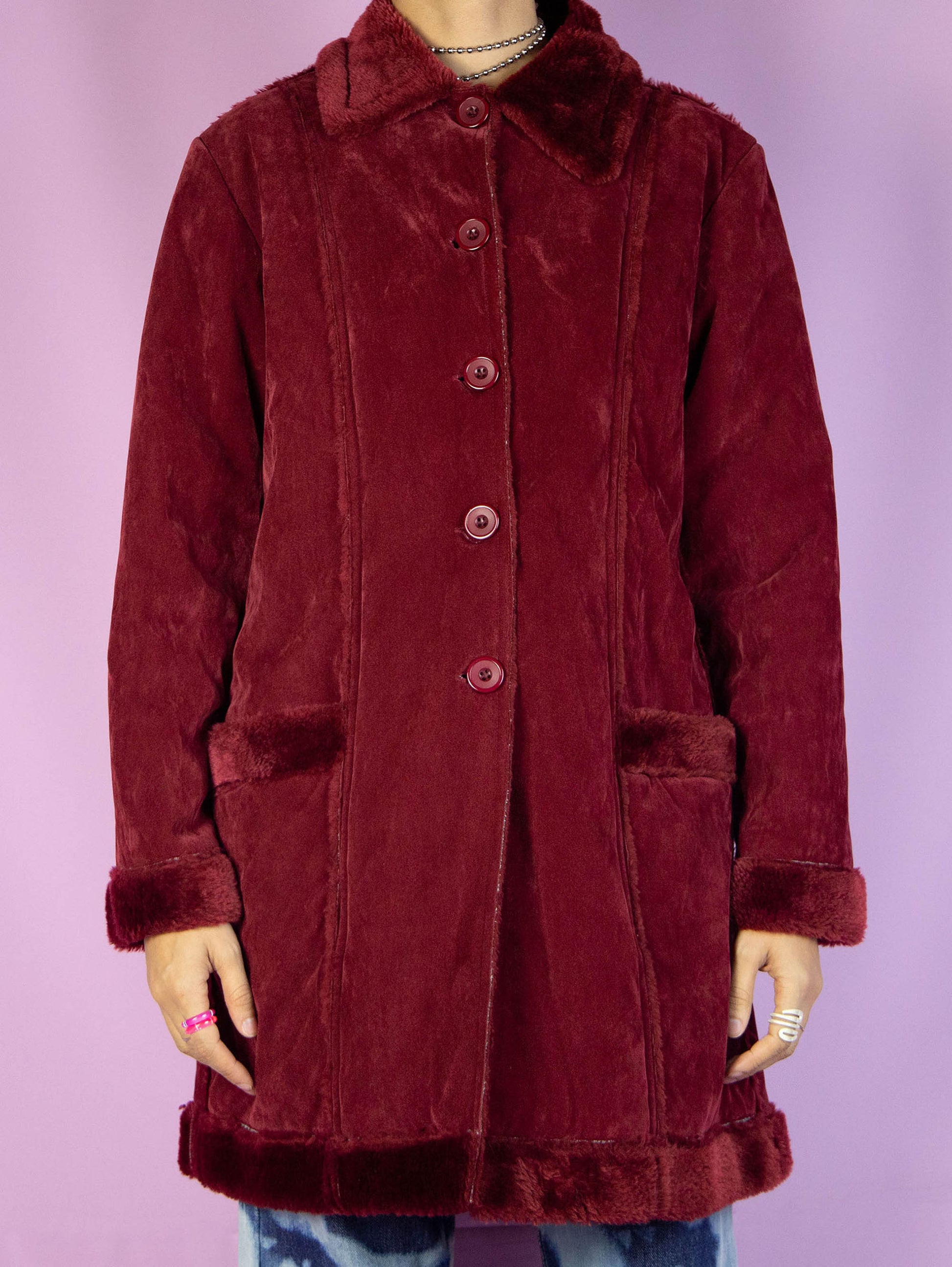 The Y2K Dark Red Faux Fur Coat is a vintage 2000s winter faux suede statement jacket with faux fur interior, collar, and cuffs, featuring pockets and a button closure.