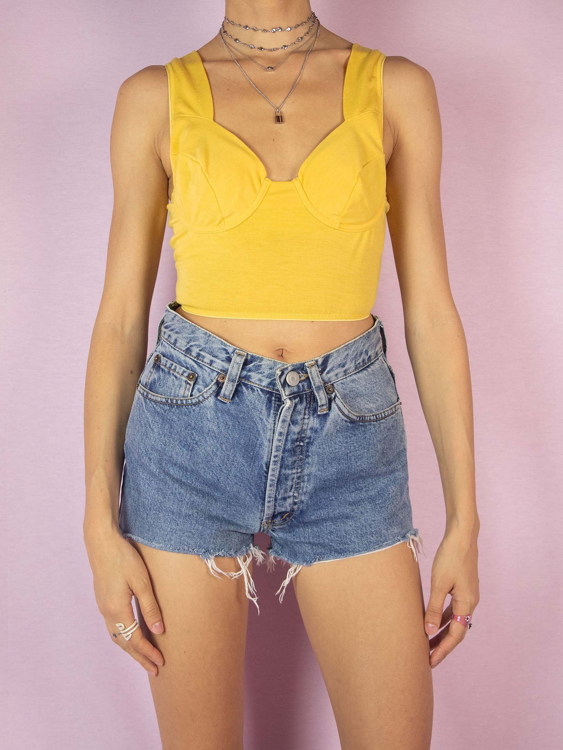 The Vintage 90s Yellow Bustier Crop Top is a sleeveless summer party top with elastic at the waist and wired underbust. Fits like an 85 EUR cup bra size.