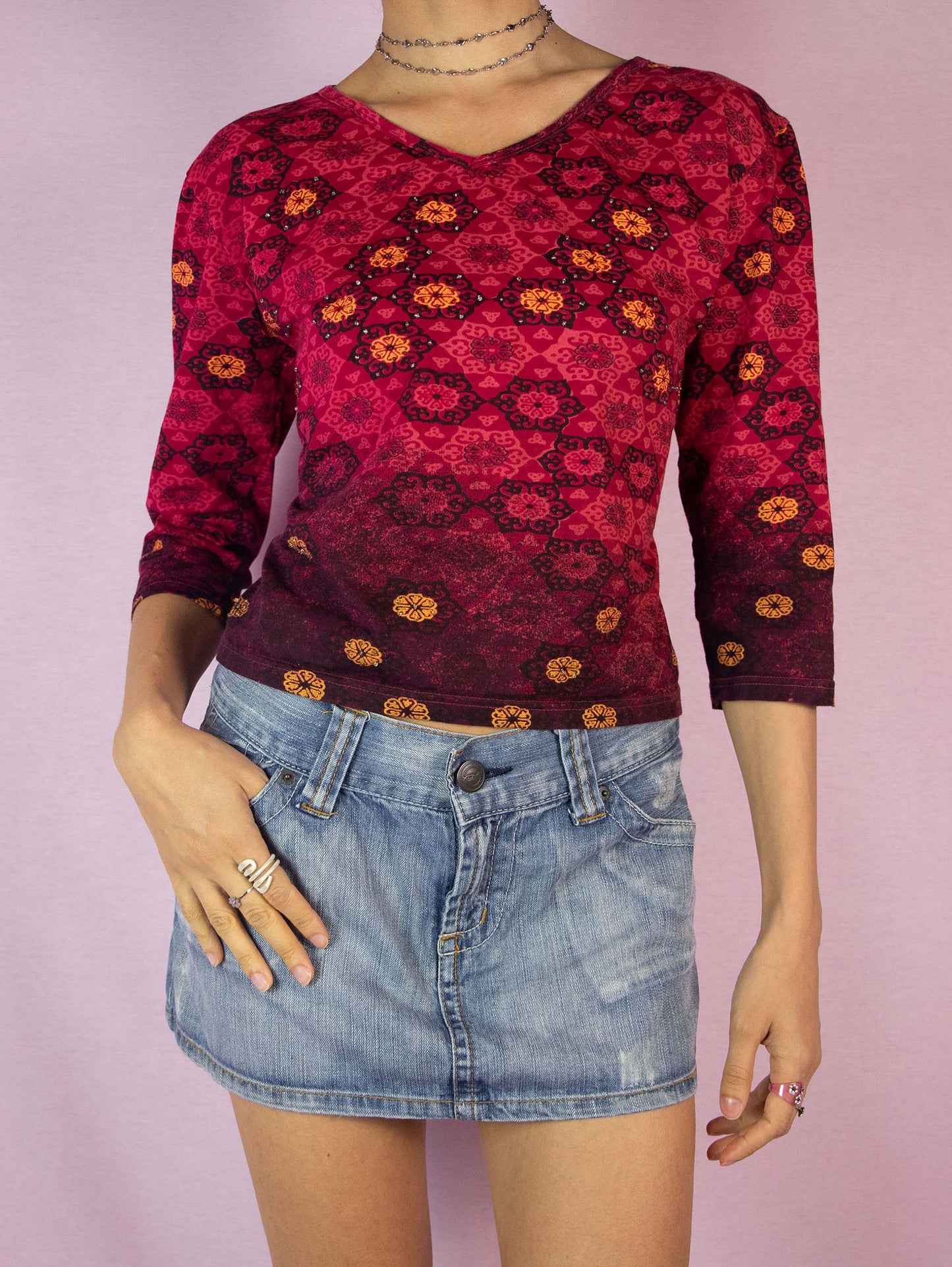 The Y2K Red Abstract Print Top is a vintage 2000s burgundy boho half-sleeve shirt with a graphic pattern and embellished with beads.