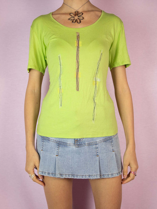 The Y2K Lime Green Tee is a vintage 2000s cyber minimalist short-sleeved shirt with applique details. Made in Spain.