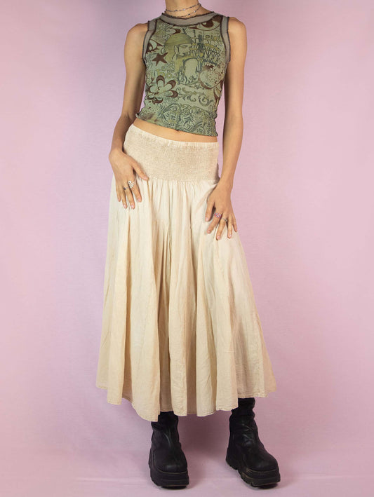 The Y2K Beige Cotton Maxi Skirt is a vintage 2000s voluminous and flowy full summer beach-style boho midi skirt with shirred elastic waist.