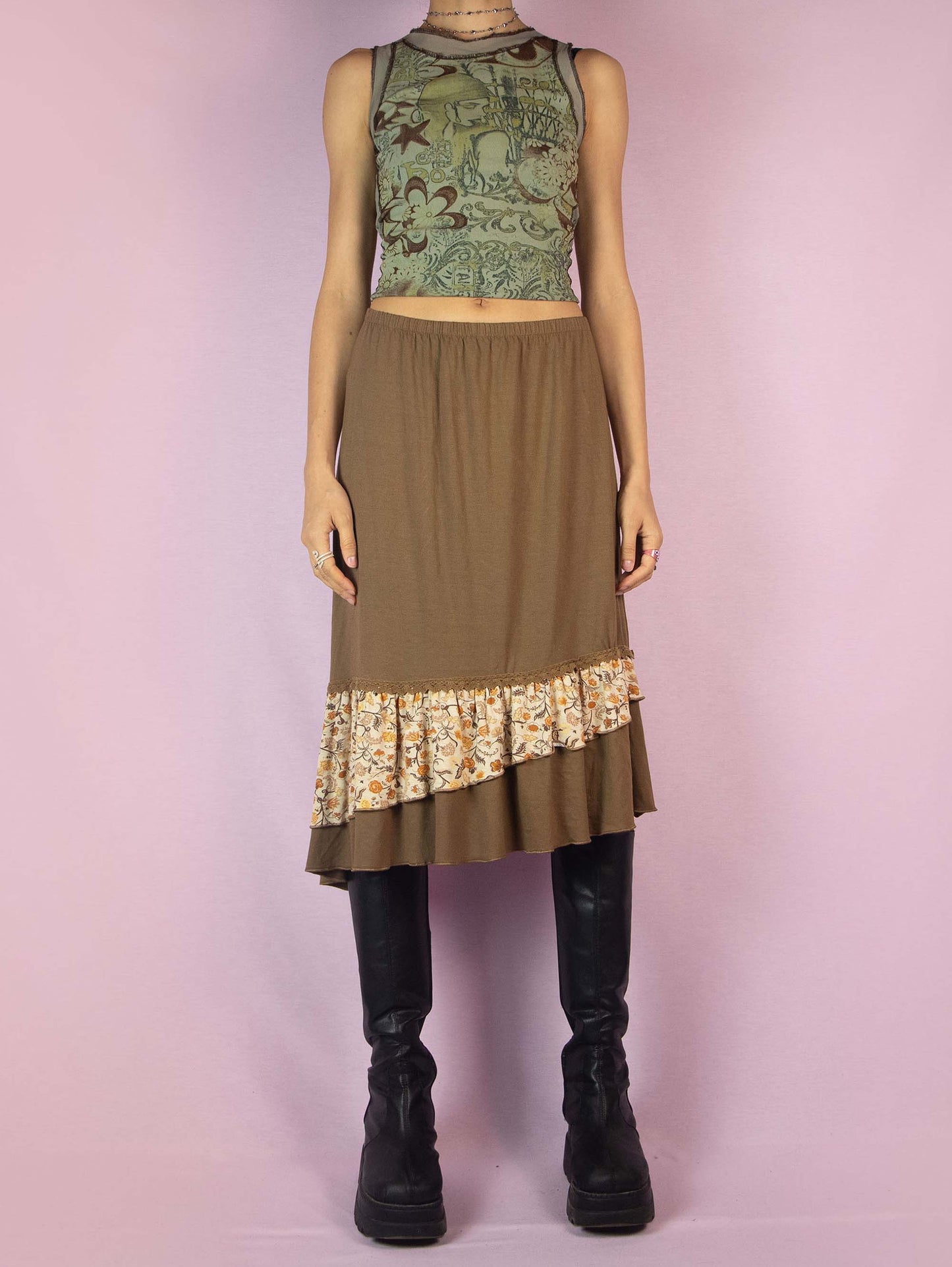 The Y2K Asymmetric Brown Midi Skirt is a vintage 2000s fairy grunge cottagecore style skirt with an asymmetric floral print ruffle hem and elastic waist.